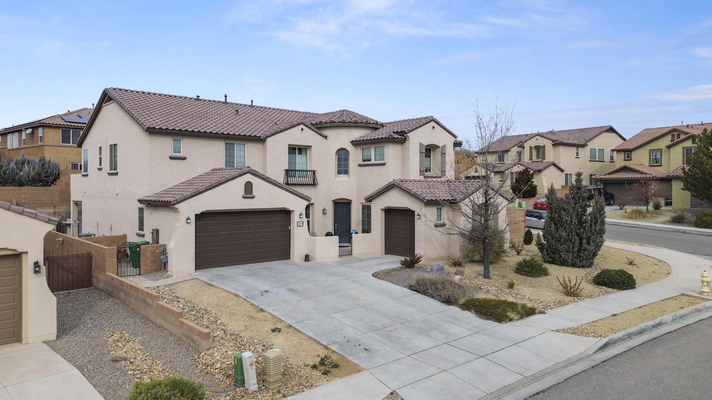 This stunning Pulte-built home (2013) offers over 4,223 sq ft of versatile living with 6 bedrooms an Office & 4 full baths & a half bath, plus a spacious 4-car garage. Nestled on a generous corner lot (+10,454 sq ft), it opens into a charming courtyard and grand foyer featuring a wrought-iron staircase and high-ceiling formal living room. The chef's kitchen with a butler's pantry flows seamlessly to a breakfast nook, coffee station and covered patio complete with a cozy fireplace and outdoor grill--an entertainer's dream. Enjoy two master suites (one on the main), a loft, engineered hand-scraped wood floors, refrigerated air, updated primary bath, and walk-in closets in every room and bonus VIEWS!