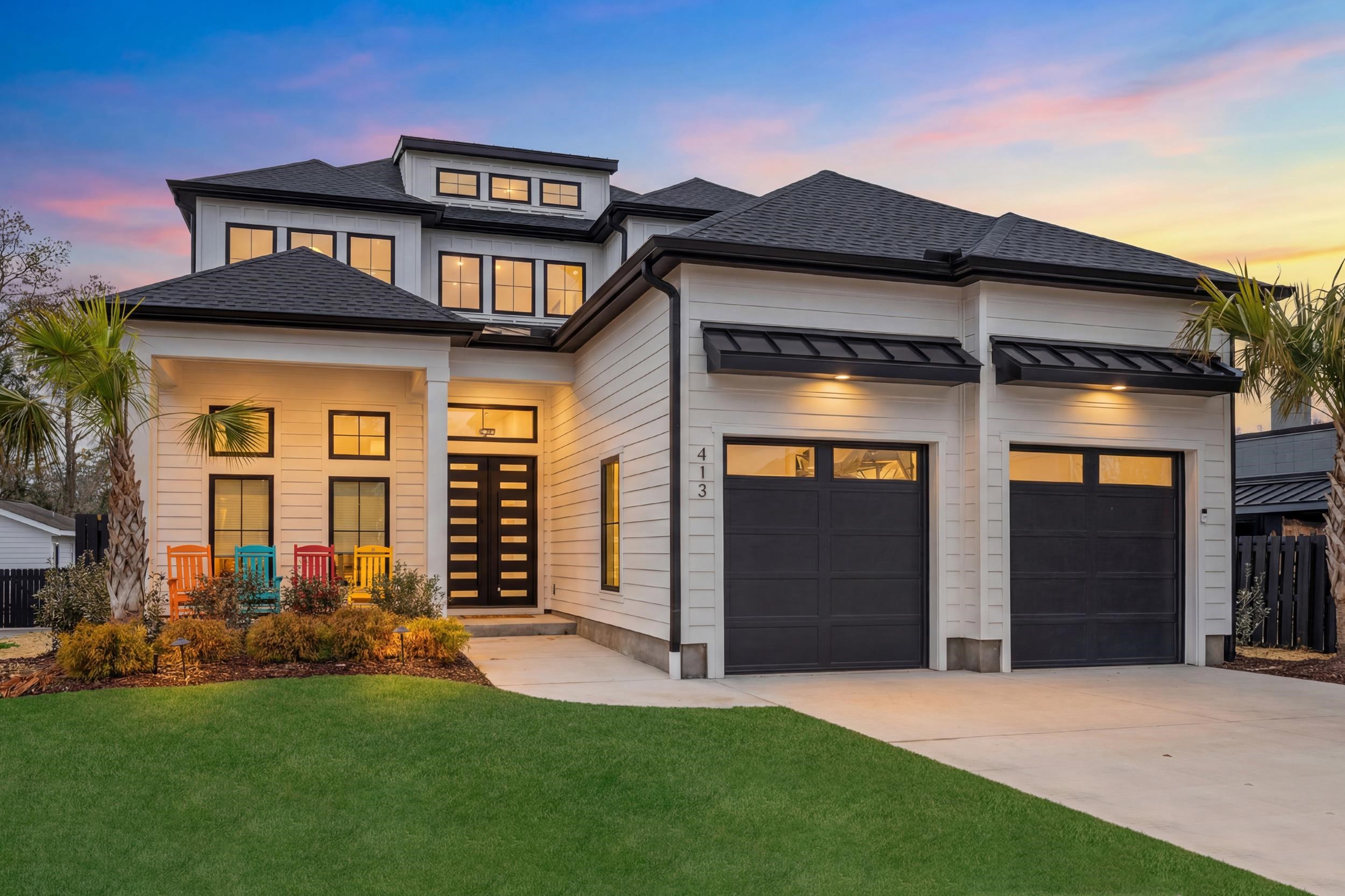 Introducing 413 N. Highland Way — a rare contemporary home opportunity east of Kings Highway in the highly desirable Highlands section of Myrtle Beach. This exceptional residence seamlessly blends European design with contemporary Renaissance influences and refined coastal living. Offered fully furnished, the home features a heated pool and an expansive outdoor living area designed for effortless entertaining. With four bedrooms and three-and-a-half baths, this thoughtfully designed property combines premium finishes, architectural detail, and functional livability. Upon arrival, a covered front porch and solid iron entry door welcome you into a bright interior highlighted by 12-foot ceilings, coffered ceilings, and tray ceilings throughout. The well-designed floor plan includes a spacious two-car garage with a conveniently located laundry room just inside the entry. The gourmet kitchen serves as the centerpiece of the home, anchored by an oversized quartz double-waterfall island and matching quartz backsplash. A generous walk-in pantry and professional-grade Jenn-Air appliances elevate both form and function. The kitchen flows seamlessly into the family room, where coffered ceilings and oversized sliding doors overlook the outdoor summer kitchen and heated black lagoon plaster pool with paver surround—creating a perfect setting for both everyday living and entertaining. The owner’s suite offers a luxurious retreat with tray ceilings, a spa-inspired bath featuring an expansive walk-in shower, and two oversized walk-in closets. Ascending to the second level, illuminated by waterfall LED stair lighting, you’ll find three additional bedrooms, two full baths, and a spacious flex area ideal for an office, media room, or private guest retreat. The home is elevator-ready, with a designated shaft currently utilized for additional storage; installation can be completed with minimal modification. European 10¼-inch-wide white oak hardwood flooring runs throughout the home, complemented by standing seam metal roof accents, black Anderson windows, and abundant natural light. The property offers approximately 3,251 heated square feet and 4,143 total square feet. Located in a non-HOA, non-flood zone area where short-term rentals are not permitted, this home provides both privacy and long-term value. Just minutes from pristine beaches, championship golf courses, premier shopping, and award-winning entertainment such as The Carolina Opry, the location places the very best of coastal living at your doorstep. This impeccably crafted residence presents a rare opportunity to own a timeless coastal retreat in one of Myrtle Beach’s most sought-after neighborhoods.