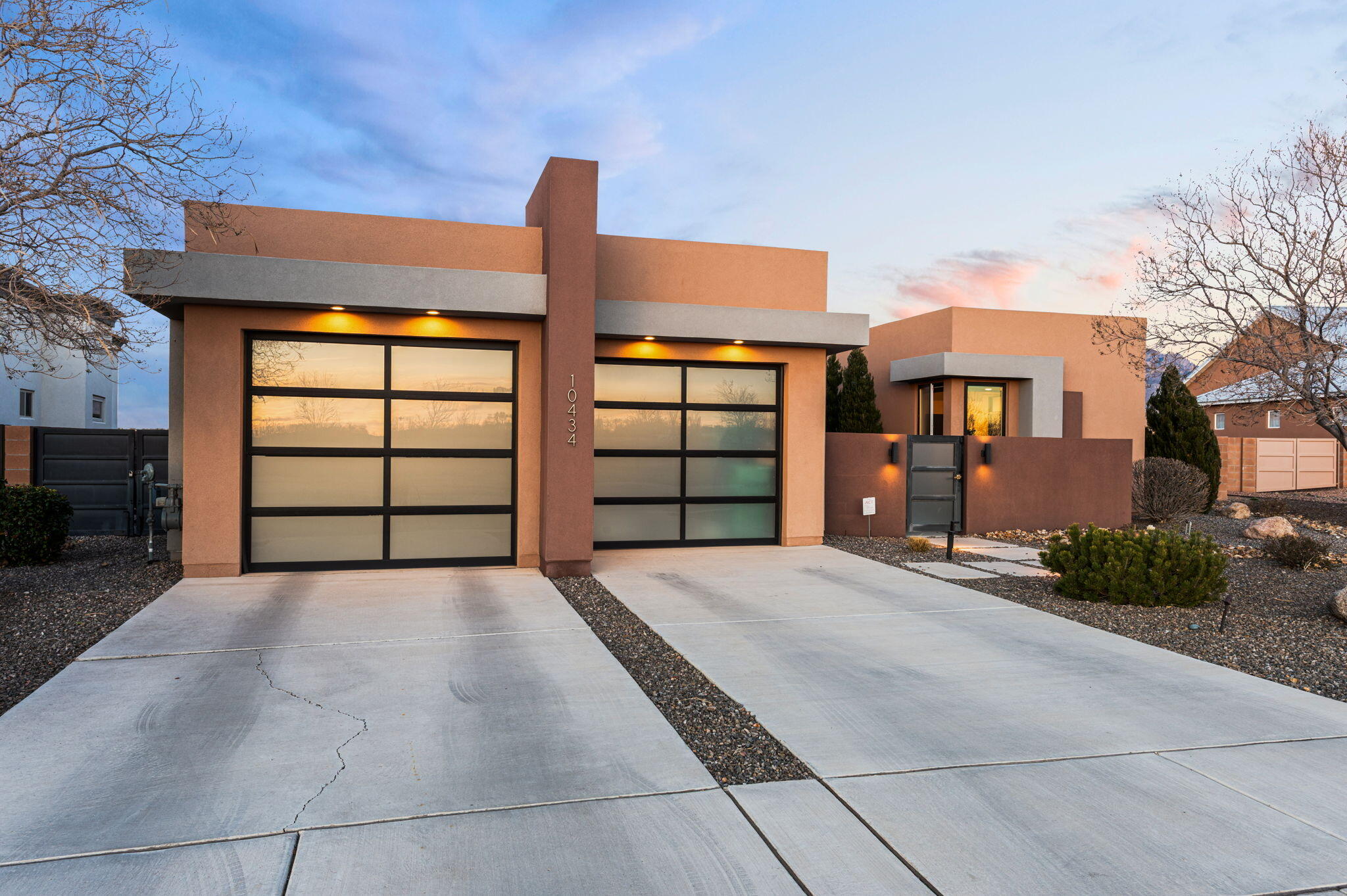 Backing up to Balloon Fiesta Park with some of the most amazing views in Albuquerque! This contemporary custom home offers a light, bright and open floor plan with sleek architectural design, custom finishes, tile and countertops. The stunning chef's kitchen features Bellmont cabinetry installed by Poulin Design Center, blending style and function. Two commercial-grade retractable doors open the living space to a covered patio for seamless indoor/outdoor living. Enjoy a professionally landscaped backyard with fountains and fruit trees, .25 acre homesite, 360 view deck and 3-car garage. Located in a small private gated community with trails, basketball court and cornhole area. Paid-off solar panels add efficiency and long-term savings.