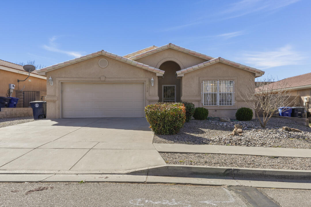 Welcome to 6612 Ladrillo Pl NE in the desirable NE Heights of Albuquerque. Tucked on a quiet neighborhood, this home offers a prime location near top-rated schools, parks including North Domingo Baca Park, and convenient shopping and dining with easy access to Paseo del Norte. This light open floor plan is great for entertaining . Vaulted ceilings and fireplace.  Wrought iron  for security. The beautiful backyard features lush, mature plants creating a private, serene retreat perfect for relaxing or entertaining.