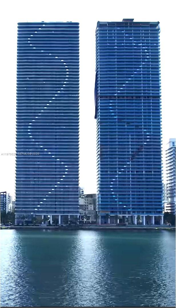Luxury waterfront living at Aria Reserve South Tower in Edgewater Miami, part of the tallest waterfront residential twin-tower development in the United States. This stunning 2-bedroom + den, 3-bathroom residence offers approximately 1,306+ SqFt of bright open living space with floor-to-ceiling windows and breathtaking Biscayne Bay and Miami skyline views. The open-concept living and dining areas flow seamlessly to a private balcony overlooking the bay, creating the perfect indoor-outdoor lifestyle. The modern designer kitchen features premium appliances, stone countertops, custom cabinetry, and a spacious island ideal for entertaining. The primary suite offers direct terrace access, a spa-inspired bathroom, and generous closet space. The second bedroom includes its own en-suite bathroom, while the spacious den can be used as a home office, guest space, or additional lounge area. Residents enjoy resort-style waterfront amenities including a bayfront swimming pool, tropical gardens, tennis courts, spa, concierge services, and a state-of-the-art fitness center offering private training sessions and fitness classes available to residents. Ideally located in the heart of Edgewater Miami, just minutes from Midtown, the Design District, Wynwood, Downtown Miami, and Miami Beach.