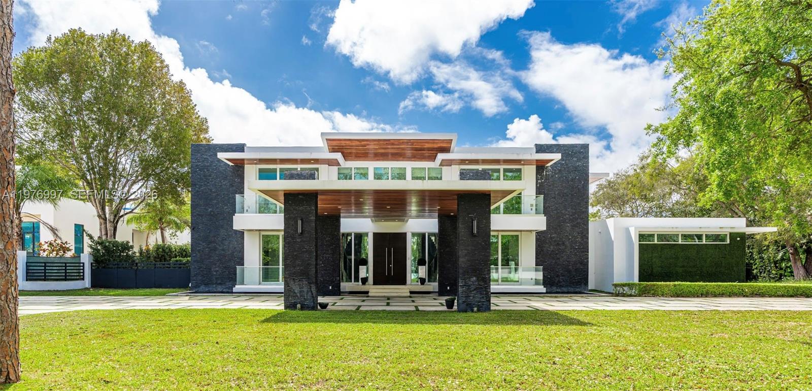 Motivated Seller ,Bring All Offers!La Premiere Realty is pleased to introduce this extraordinary 2020 contemporary estate in Pinecrest, where architectural brilliance and refined luxury meet behind private gates. Spanning 10,122 sqft of adjusted living area, the residence showcases a striking modern façade with clean lines, natural stone accents, and a dramatic covered entrance that sets the tone for the elegance within.This exceptional residence features 8 bedroom, 10/1 bathroom, a private elevator, and a 3-car garage, all finished with impeccable craftsmanship and high-end materials. At the heart of the home lies a gourmet chef’s kitchen equipped with premium Wolf appliances, custom cabinetry, and generous preparation space, perfect for entertaining.The primary suite offers tranquil views of the resort style backyard, two expansive walk-in closets, and a spa-inspired marble bathroom with a soaking tub and oversized glass shower.The estate includes a complete security system and integrated speakers throughout the home.Enjoy a stunning infinity edge pool, sunken lounge, and covered summer kitchen surrounded by mature palms, creating a private resort-style setting.