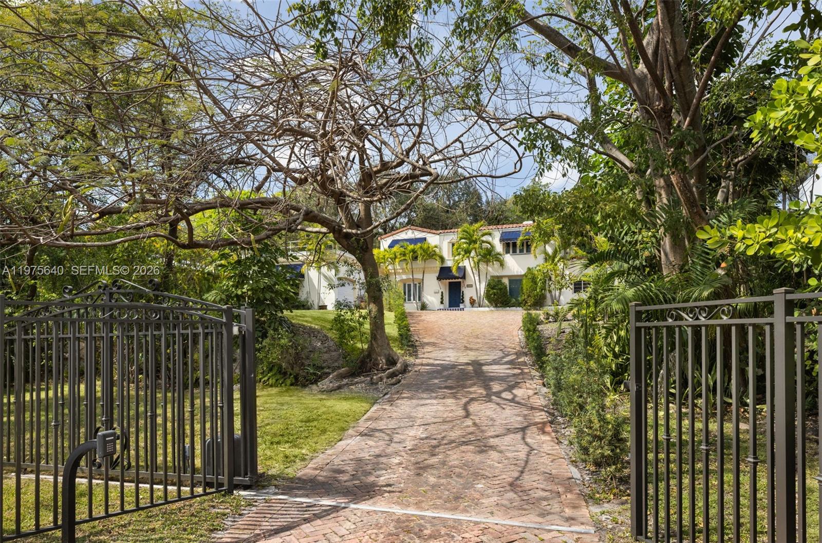 Positioned along the coveted South Bayshore hillside, this gated residence sits on an expansive 19,800 SF lot—offering a unique opportunity to renovate or create a new estate in one of Coconut Grove’s most prestigious residential corridors. Mature tropical landscaping frames the property, while the elevated setting provides privacy and a sense of retreat just moments from the energy of the Grove and Biscayne Bay. The existing home offers generous living spaces across two levels, with 2 bedrooms and 2.5 baths on the main floor and 3 bedrooms and 2 baths upstairs. Formal living and dining rooms define the interiors, highlighted by a fireplace-anchored living room and a spacious family room with French doors opening to the terrace. A pool, expansive yard, two-car garage, and rooftop access further enhance the property’s versatility and future potential.Just steps from Biscayne Bay and minutes from Coconut Grove’s marinas, parks, and vibrant village center, this exceptional property offers the scale, location, and elevation to reimagine a signature residence along iconic South Bayshore Drive.