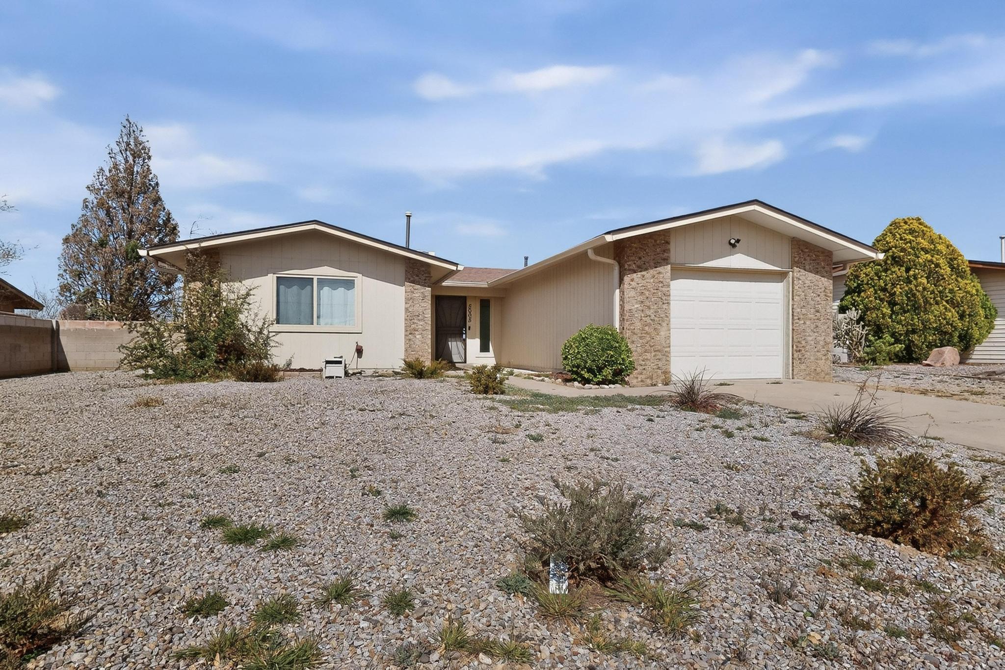 Charming 2 bedroom home located in a prime location, just minutes from Balloon Fiesta Park! Light and bright floor plan includes recent updates throughout: new stucco, windows, flooring, and ceiling fans. The beautifully remodeled kitchen features stainless steel appliances, pantry, and updated finishes. Large living area with wood burning fireplace. Spacious bedrooms and both bathrooms with new vanities. The roof is less than one year old, providing added value and peace of mind. Huge backyard with open patio perfect for relaxing, entertaining, or enjoying New Mexico's beautiful weather. Plenty of room to create your own outdoor retreat. Move-in ready! A great opportunity in an excellent location with quick access to I-25 for easy Albuquerque commutes.