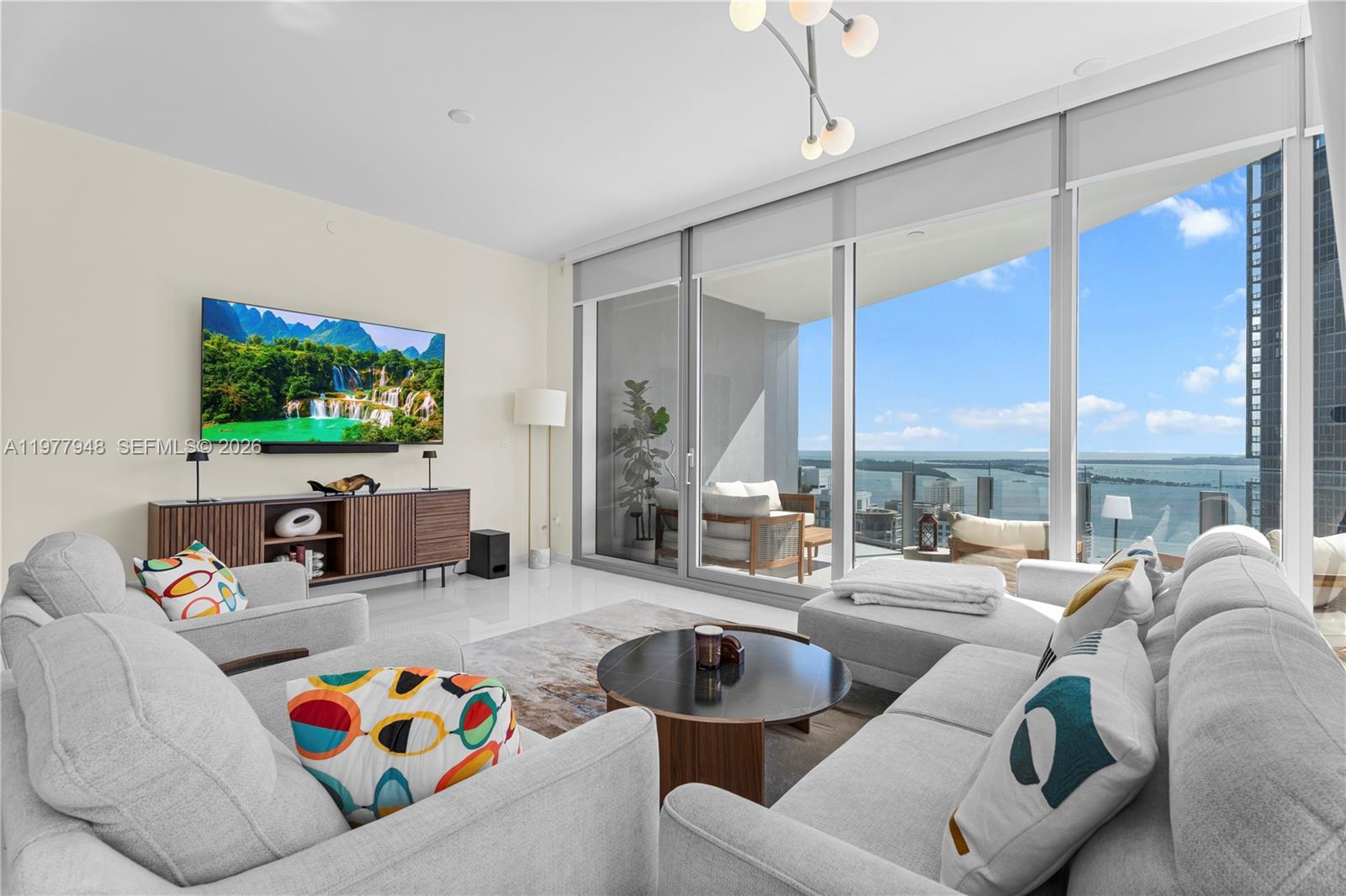 Luxury furnished residence at the iconic Aston Martin Residences, Unit 4007. This brand-new high-floor condo offers spectacular water and city skyline views through dramatic floor-to-ceiling windows, complemented by soaring ceilings, built-in closets, and automated window treatments. The residence features premium finishes, a sleek gourmet kitchen, and a spacious primary suite, delivering a sophisticated turnkey lifestyle. Residents enjoy over 42,000 SF of world-class amenities, including a multi-level fitness center, yoga studio, full-service spa with sauna and steam rooms, indoor and outdoor pools, private cabanas, grand salon and lounges, business center, conference rooms, movie theater, children’s playroom, golf simulator and art gallery and marina access. Exclusive beach service is provided at the Bentley Beach Club in South of Fifth, with transportation via the building’s Blacklane house car service. The Blacklane service is also available for transportation to destinations within a 6-mile radius, or residents may choose to self-drive and use valet. White-glove concierge, valet, and 24-hour security complete this exceptional offering in a prime Downtown Miami location with easy access to Brickell, fine dining, shopping, and major highways.