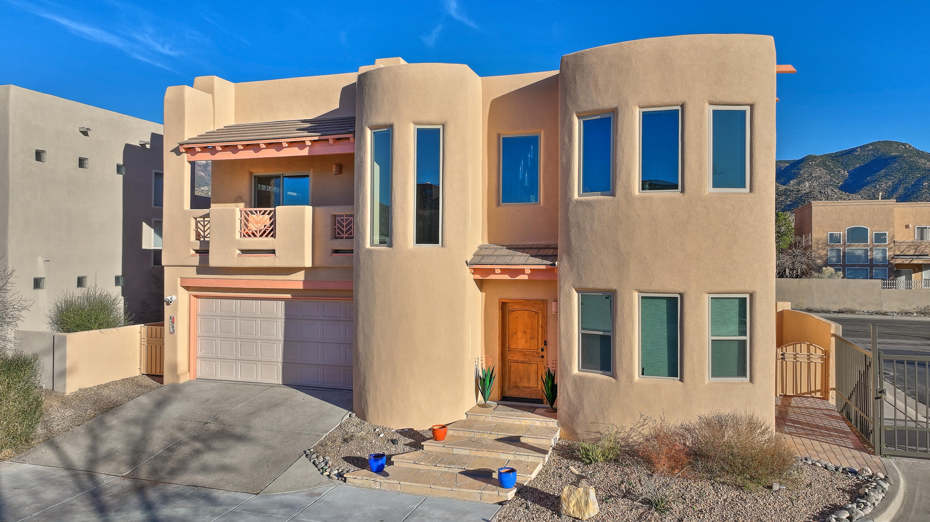 Set within the prestigious Enclave community of High Desert in Northeast Albuquerque, 6300 Calla Lilly Circle offers a rare opportunity to enjoy refined Southwest living surrounded by the dramatic beauty of the Sandia foothills. Priced at $675,000, this thoughtfully designed residence blends timeless New Mexico architecture with modern updates, creating a warm and inviting retreat in one of the city's most sought-after neighborhoods. Inside, the home showcases classic Southwestern character with soaring ceilings, exposed vigas, handcrafted stone accents, and lighted nichos that add both texture and charm throughout the living spaces. The well-designed floor plan offers three spacious bedrooms and three bathrooms, along with a versatile flex space that can easily serve as a fourth bedroom,