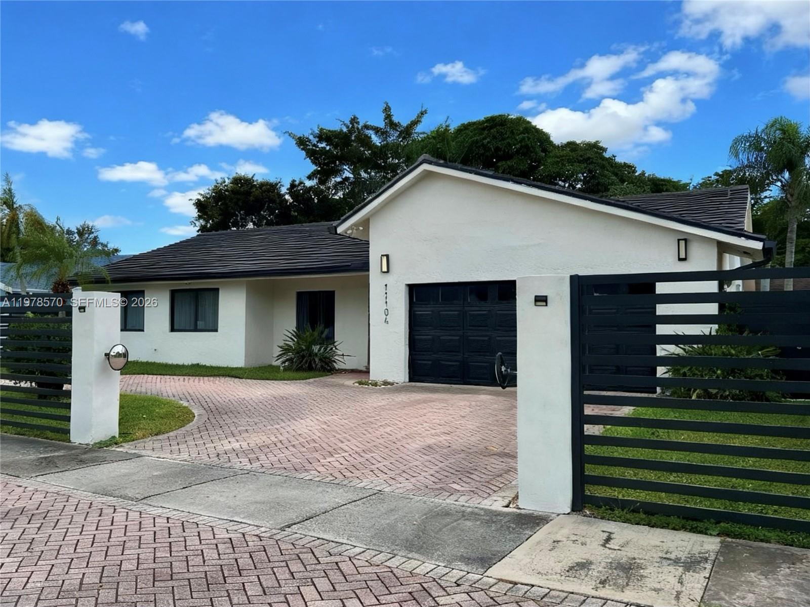 Beautiful single family home, 4 bedrooms and 2 bathrooms, a large pool with water heater, a covered terrace and a 2 car garage with a spacious circular driveway and ample space for 6 or more cars, concrete and metal fenced all around the house. Move-in ready, very spacious property with vaulted ceilings and large spacious kitchen and family room, living room and dining room in open concept. The kitchen features wood cabinets to the ceiling with granite countertop & stainless steel new appliances. It features tankless water heater. Plenty of space backyard to enjoy around the pool with family or entertain. The tiled roof was installed in 2022 with modern and heavy brown impact windows and doors hotel style that gives the property a modern touch. The air conditioner was replaced in 2022.