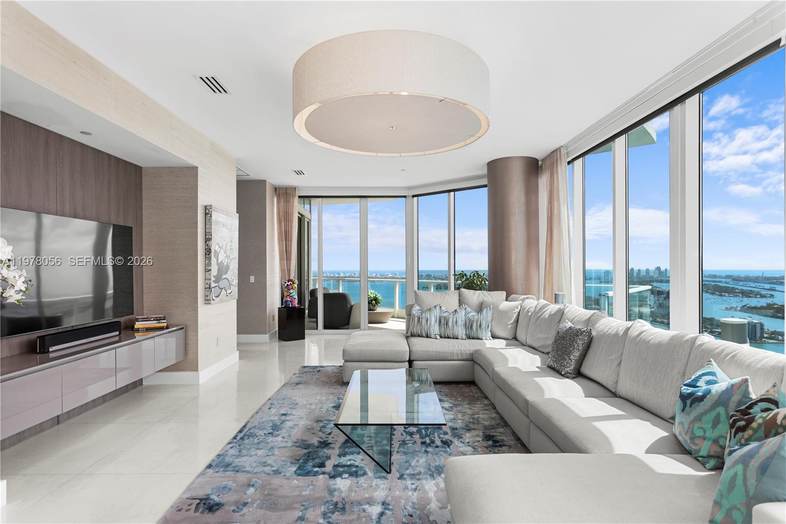 The only true penthouse at 2020 N Bayshore Drive, PH4702 offering unobstructed 360° views of Biscayne Bay, Miami Beach, and the Miami skyline from the 47th floor. With 4 bedrooms, 4.5 bathrooms and 4,055 sqft of interior space, matching the largest floor plan in the building.  Designed for indoor-outdoor living, it features 4 private balconies capturing sunrise and sunset, providing comfortable outdoor spaces year-round. Unlike oversized terraces exposed to wind, heat and rain, the balconies offer a more usable outdoor retreat. A private elevator opens directly into the foyer. Walls of glass flood the interiors with natural light, highlighting spacious living and dining areas and the split-bedroom layout. The primary suite offers water views, a spa-inspired bath and expansive closets. The fourth bedroom is ideal for in-law accommodations, staff quarters or a private office. The kitchen features Wolf appliances, including a wine cooler, dual ovens and a Miele coffee maker. The residence is featured in "Some Like It Hot: Inspiring Spaces By Florida's Hottest Designers," showcasing its design by Whitney Bloom. Located in Paramount Bay, designed by Arquitectonica with interiors by Lenny Kravitz’s, offering walkability to Whole Foods, Publix, Margaret Pace Park, and waterfront restaurants like Klaw, Casadonna and Amara. Located less than 20 mins from Miami Airport, Miami Beach, the Design District and Brickell, and near Art Basel and the Miami International Boat Show.
