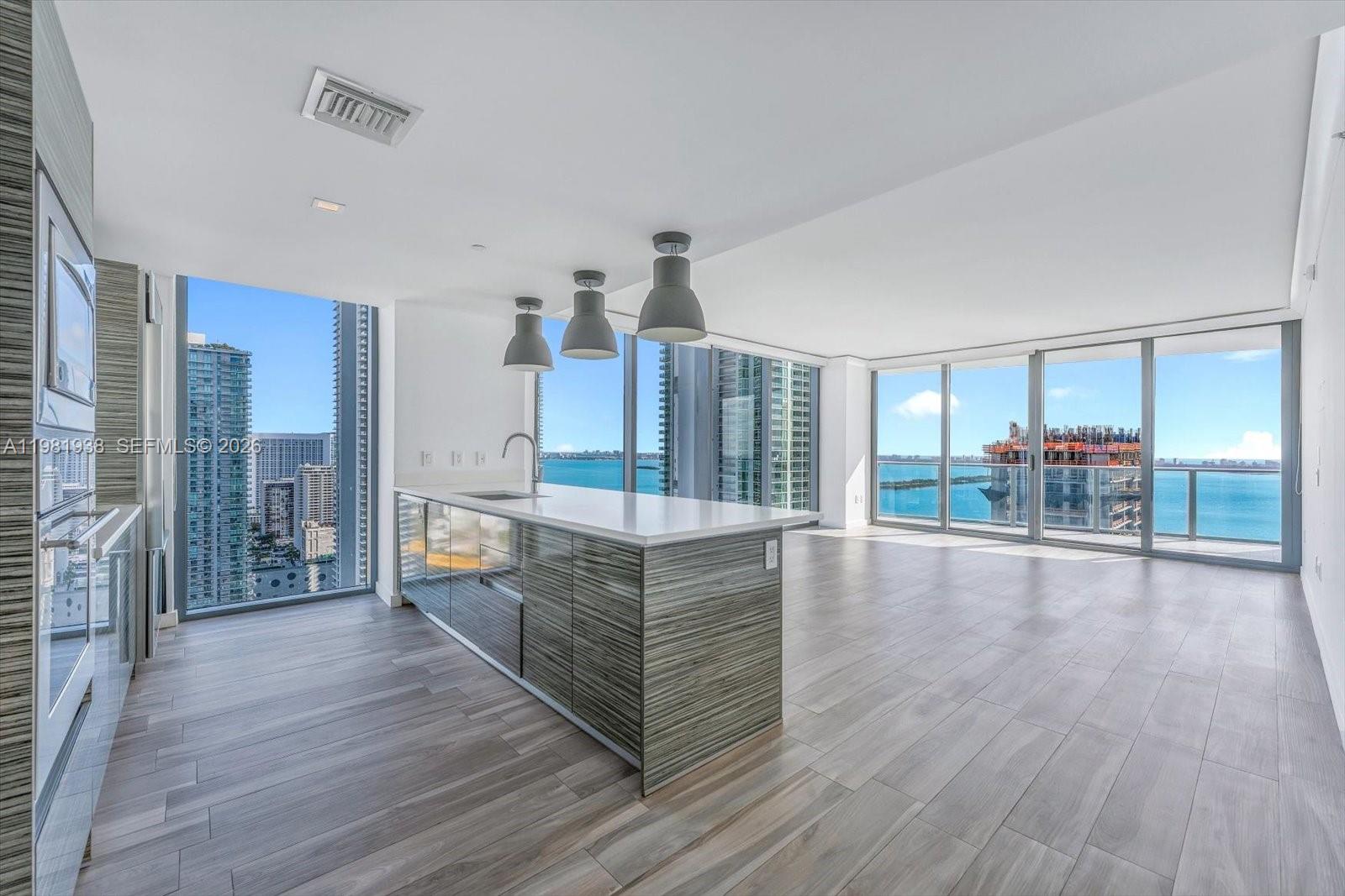 Don’t miss this exceptional opportunity — a turn-key corner residence on the 33rd floor at Icon Bay in Edgewater. This corner unit features 2 bedrooms plus a den and is wrapped in floor-to-ceiling windows showcasing spectacular, unobstructed bay and skyline views from every room.The rare flow-through layout offers two private balconies: an East-facing terrace off the living room for beautiful sunrises over the bay and a West-facing balcony from the primary suite for dramatic Miami sunsets. Residents at Icon Bay enjoy resort-style amenities, including an infinity pool overlooking the water, state-of-the-art fitness center, sky lounge, tennis courts, theater room, 24-hour security, and valet service.Perfectly positioned just minutes from Miami’s best dining, shopping, and cultural destinations — and only about 12 minutes from Miami International Airport — this residence delivers an exceptional blend of value, elegance, and convenience in one of Miami’s most desirable waterfront neighborhoods.
