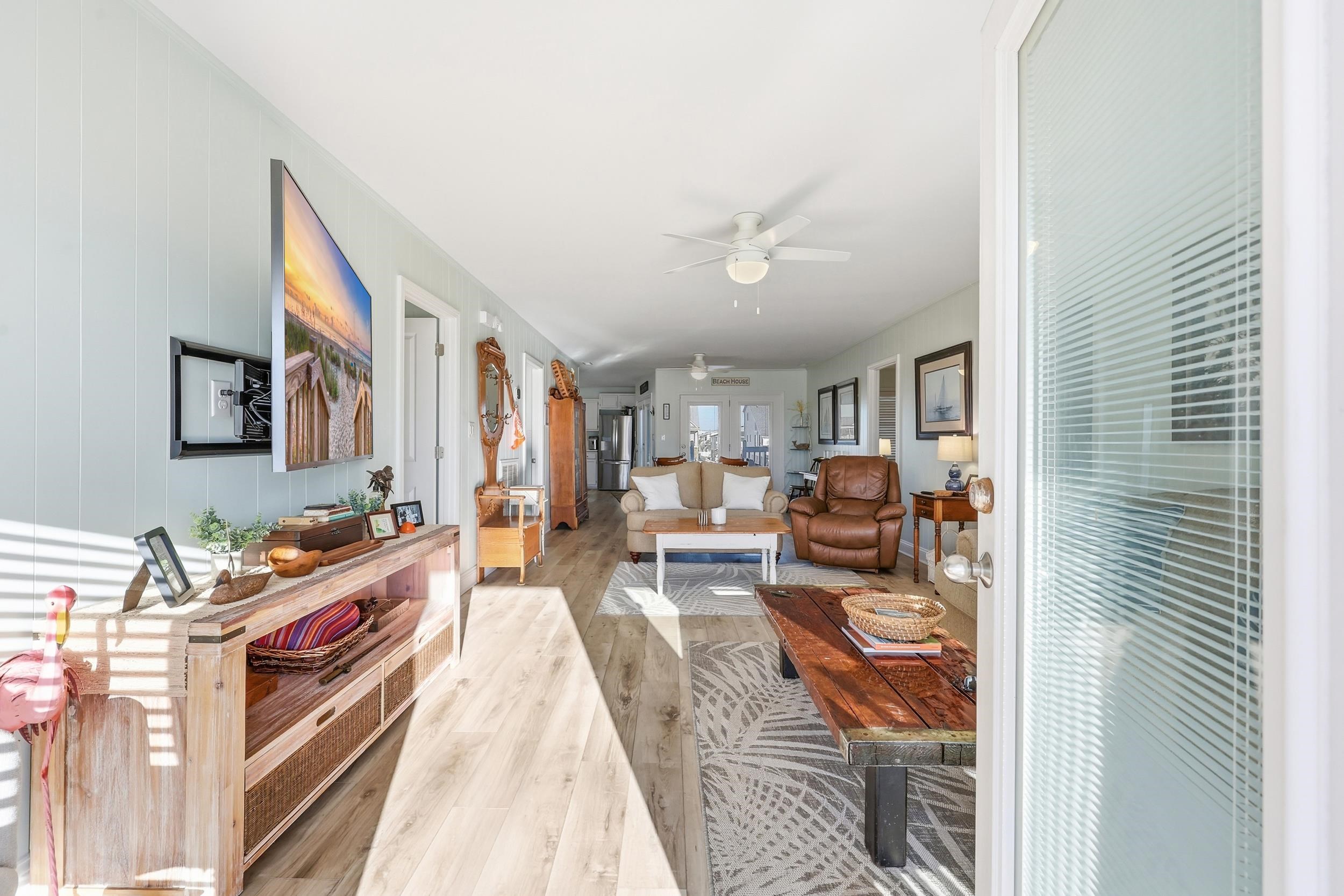 Living area with wood finished floors and ceiling fan