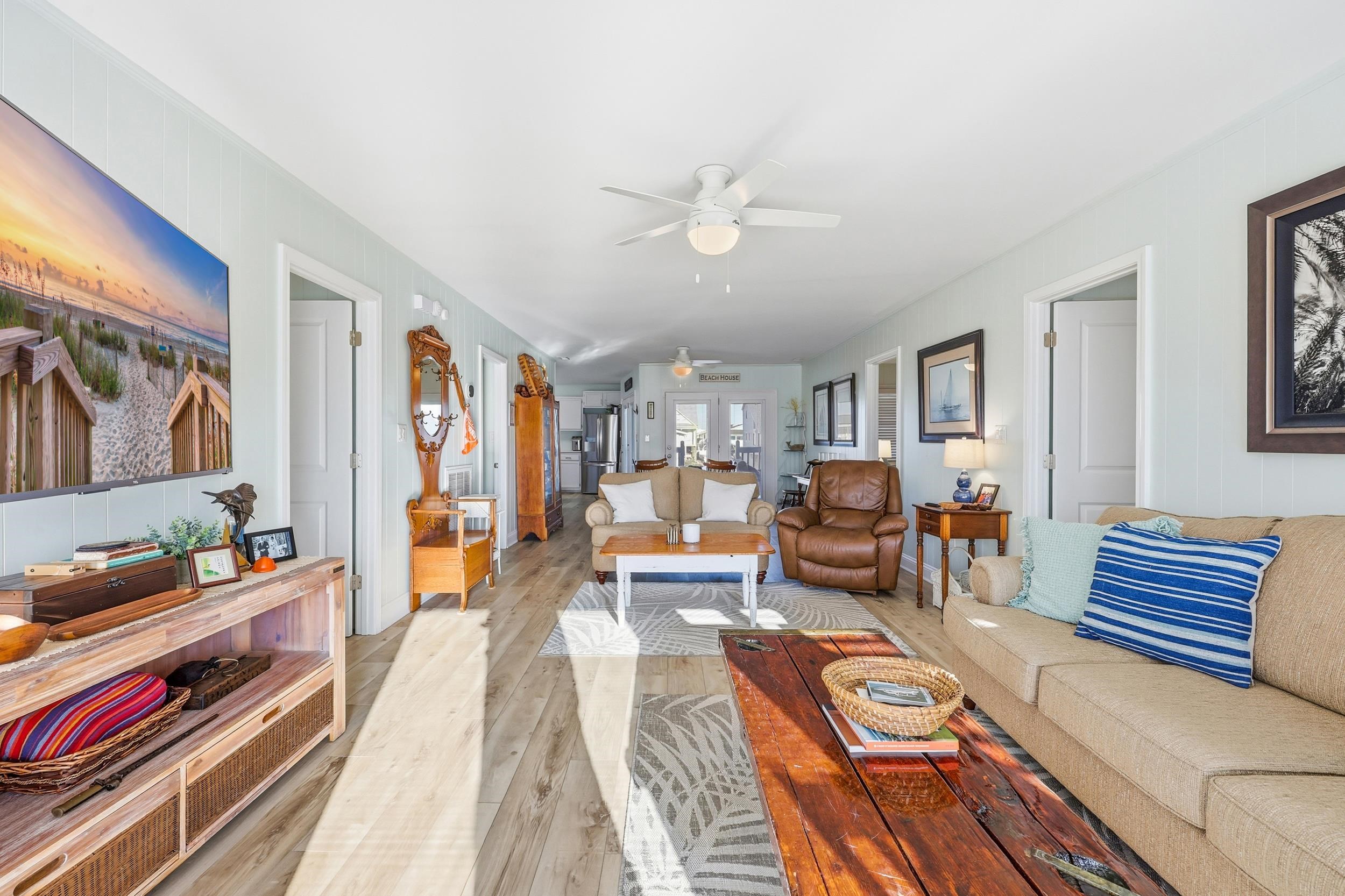 Living room featuring a ceiling fan and wood finished floors