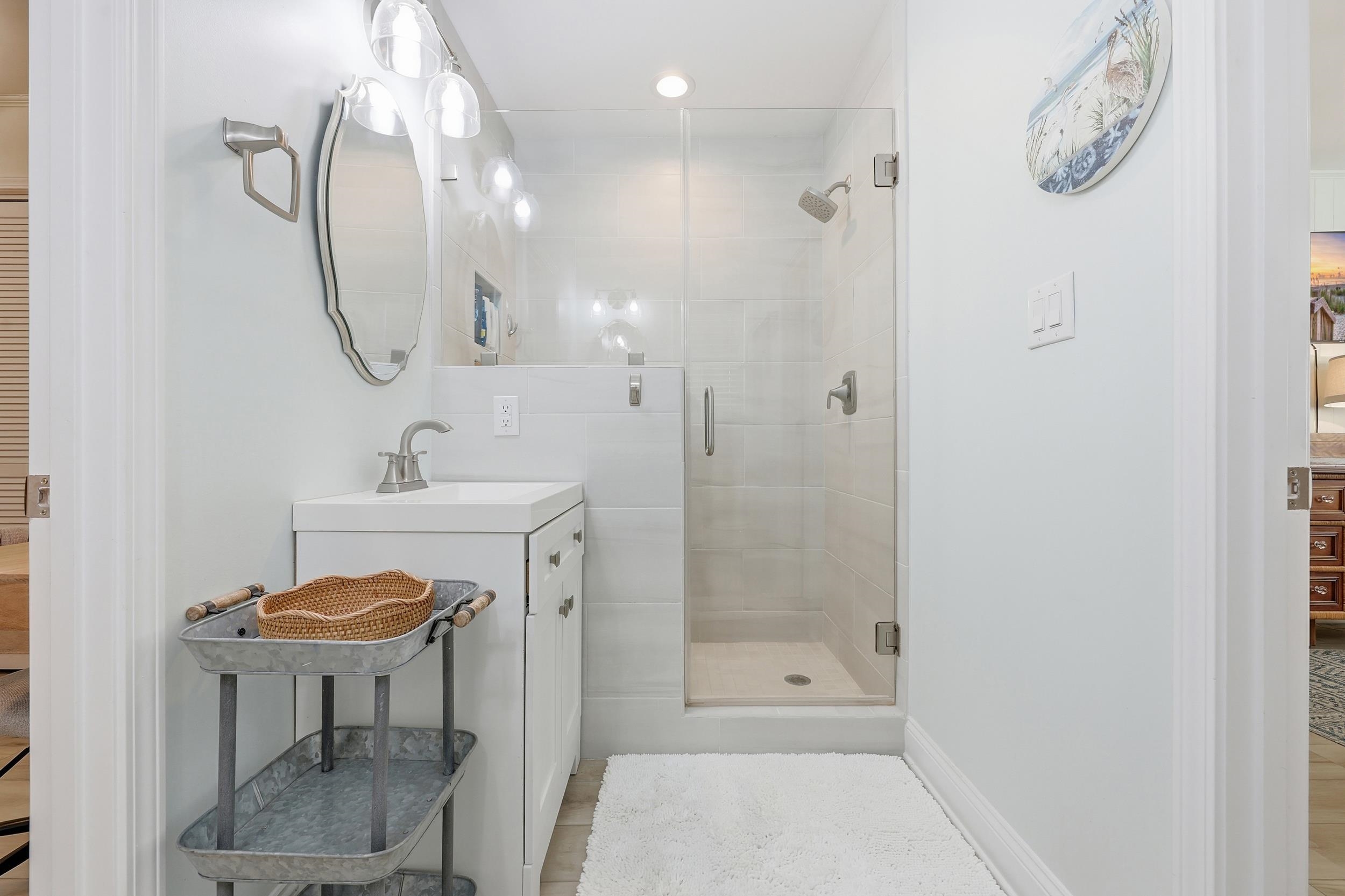 Full bathroom featuring vanity, a shower stall, and recessed lighting