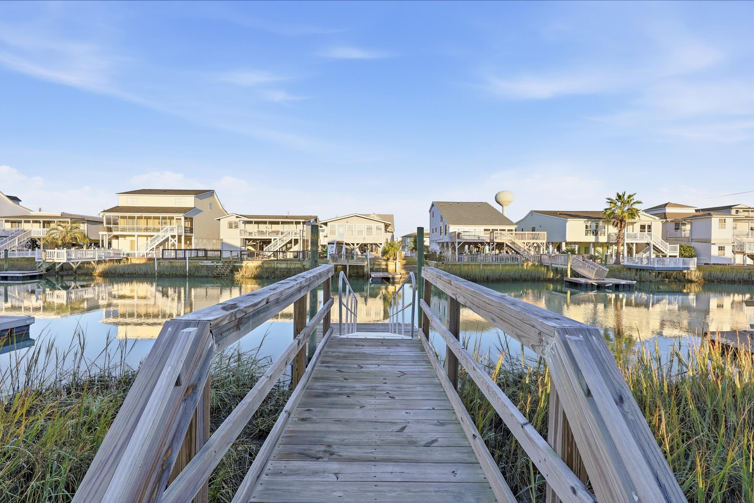 Dock with a residential view and a water view