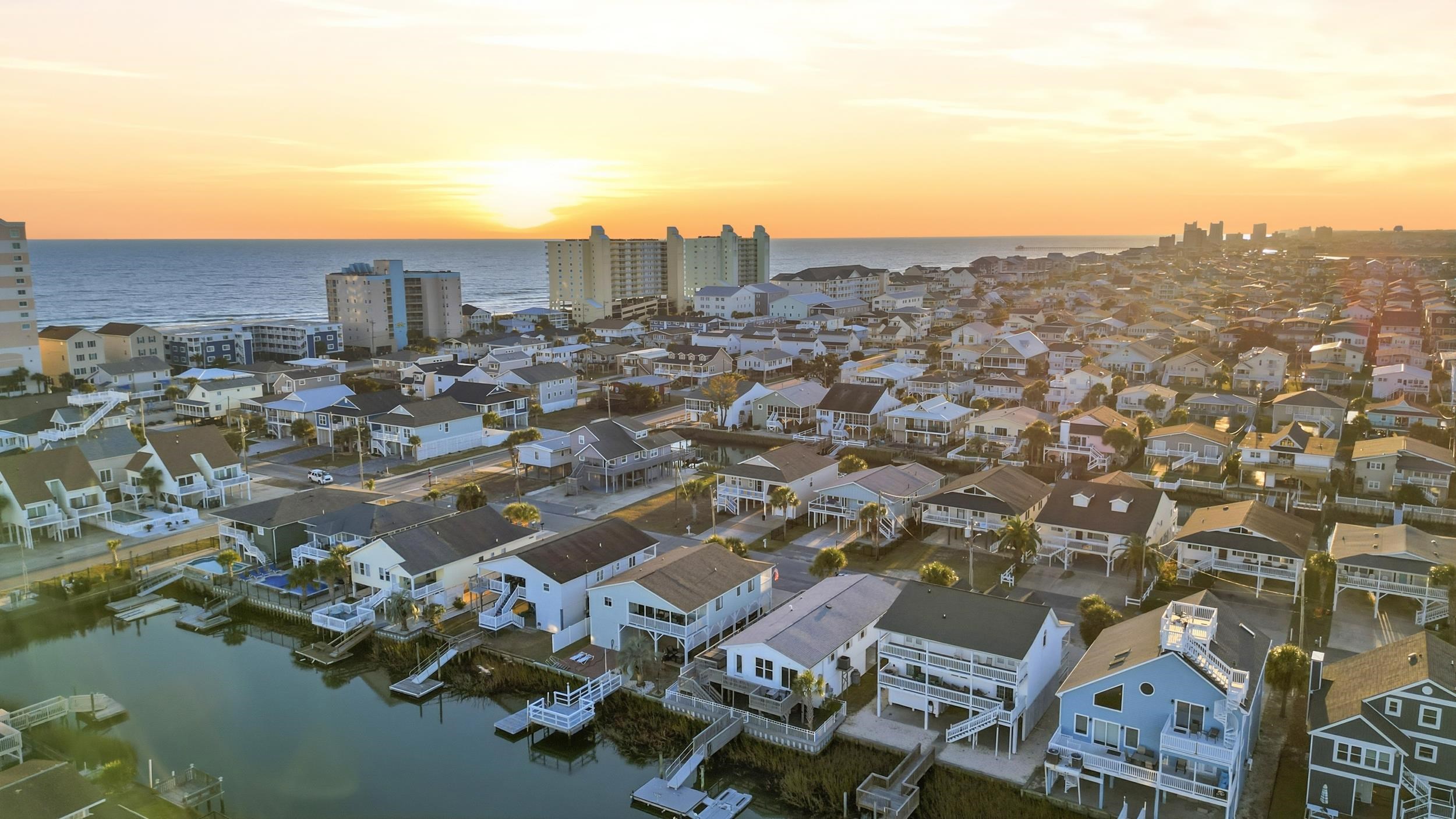 Aerial view of residential area featuring a large body of water
