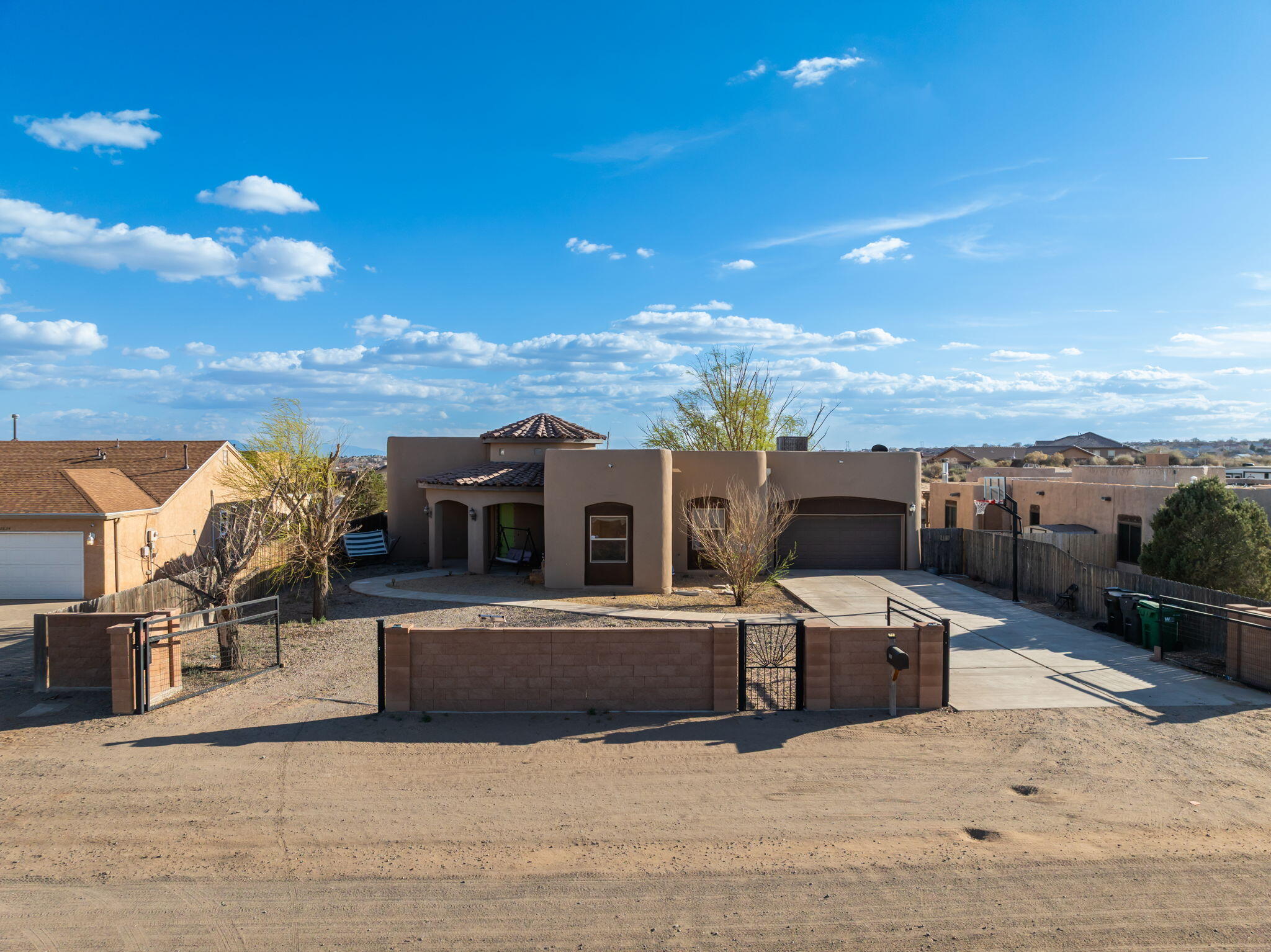 Price Reduced! Beautiful 2,527 sqft custom built home on a 1/2 acre with beautiful Sandia Mountain views just off Broadmoor Blvd. Backyard includes a detached casita that is pre-wired and pre-plumbed for future possibilities. Interior features a striking floor-to-ceiling stacked stone fireplace, jetted tubs in both bathrooms, and a tiled walk-in shower in the primary suite. Recent updates include new carpet installed in 2021 and water heater replaced August 2023. Spacious backyard includes a covered patio, a water feature (operational but not recently used) and a small playground area. The garage opens from both sides allowing access to the backyard.