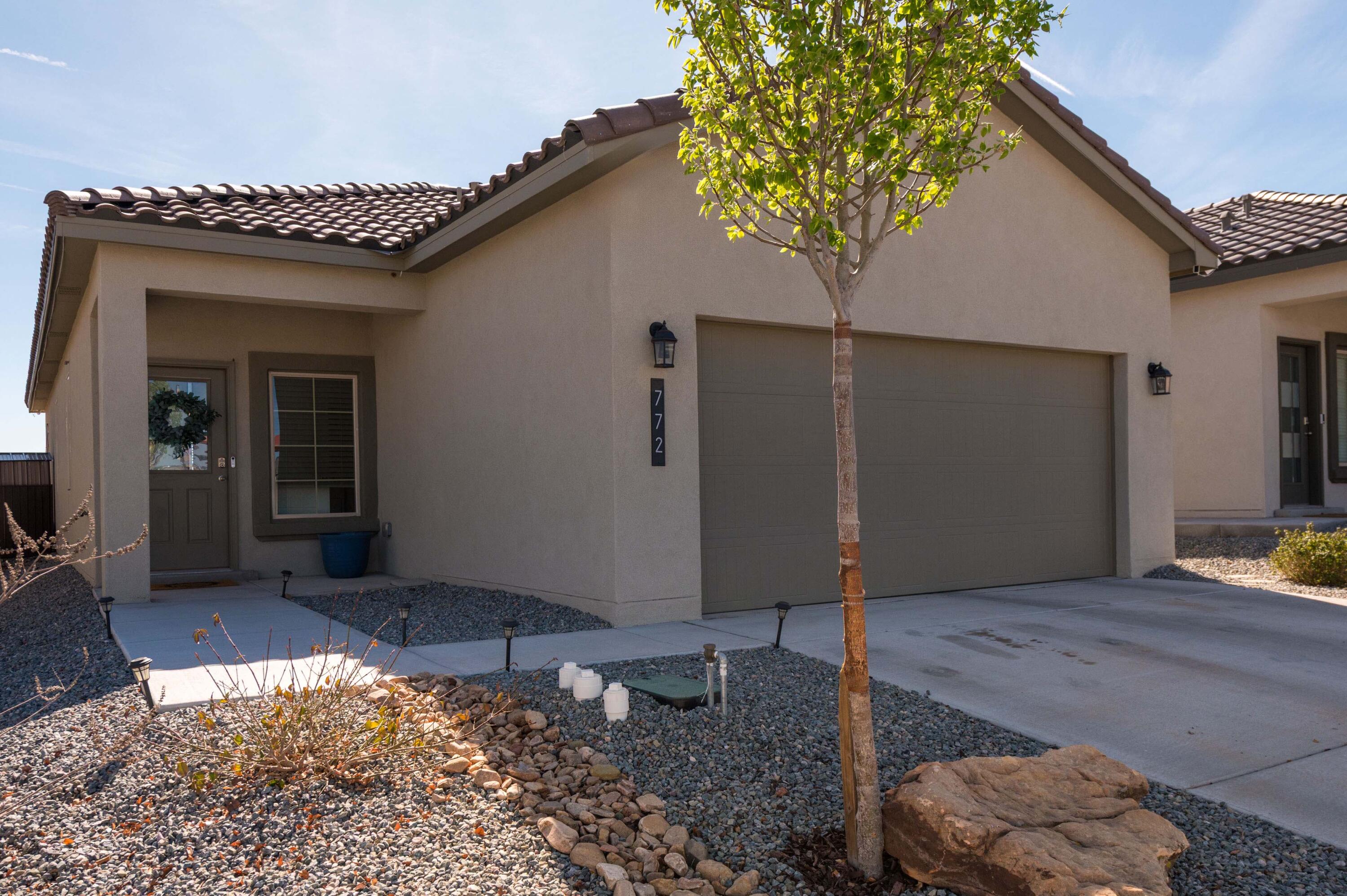 Rare opportunity to own newer construction, in a prime Rio Rancho location. This adorable, turn-key 3 bed, 2 bath, 1314 sq ft home, is move-in ready, boasts an open floorplan, tons of natural light, beautiful outdoor spaces with desirable upgrades like solar. Many major systems still under warranty. Tons of value without the hassle of putting in all your own outdoor improvements--the backyard is already outfitted for entertaining with a generous patio, lawn, a firepit, & greenhouse for gardening.  Located across from a shared open/green space & surrounded by mountain views. Coupled with quick access to local shopping, schools, RUST medical center, & I-40 or I-25, the possibilities for convenience & easy living are endless. This one is special. Come see it today.