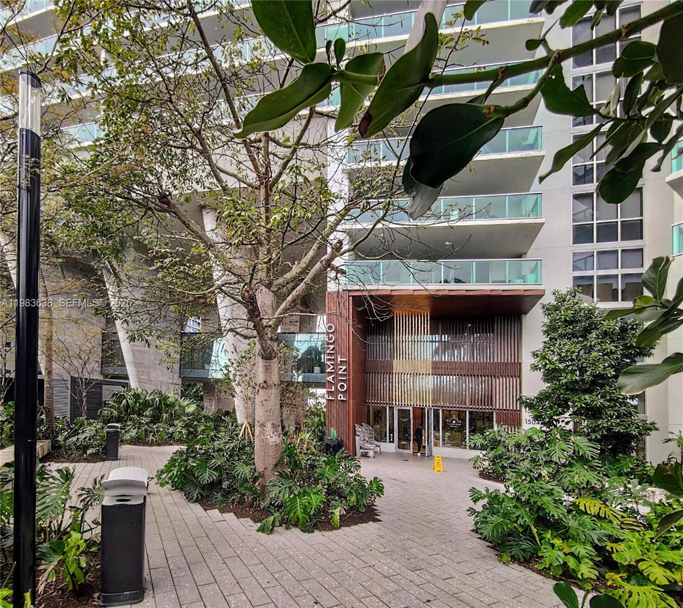 Rare turnkey 1-bedroom mid-term rental investment at Flamingo Point South Tower. Currently an active 30-day minimum furnished rental with a proven revenue history ($250-$350/night). Sold fully furnished with a transition blueprint (professional photos, vendor contacts, and proven listing copy to seamlessly launch your own profile).Unlike most units, this features RARE FULL IMPACT WINDOWS (1 of only ~3 in the entire building). Fully automated, tech-enabled interior: motorized blinds and workstation, LED lighting, Wi-Fi thermostat, Frame TV (all voice controlled), Bosch dishwasher, induction cooktop, and in-unit washer.Resort amenities: 2 bayfront pools, fitness center, and on-site dining. Step in and generate income immediately.