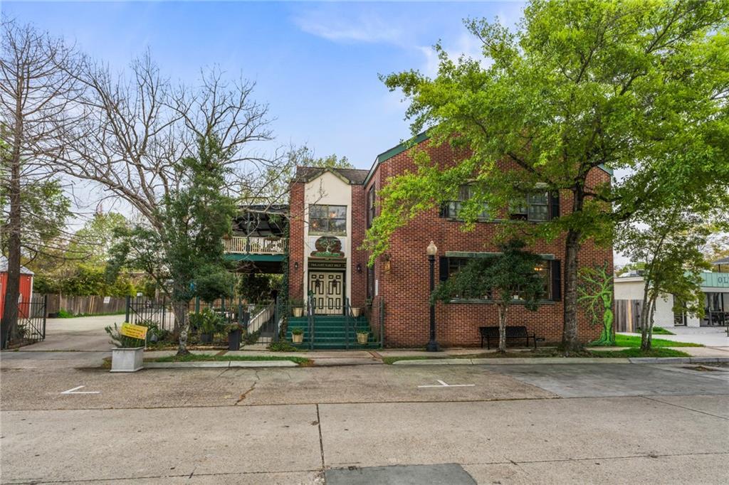 Step into a rare opportunity to own a true historic landmark in the heart of Olde Towne Slidell. Built 1905, this remarkable mixed-use property blends timeless character with modern functionality, offering exceptional live-work lifestyle or high-potential investment opportunity in one of Slidell's most vibrant and walkable districts. Positioned directly on the parade route, the property places you in the center of the festivals, culture, and energy that define Olde Towne living. From the expansive 16' x 30' second story balcony, enjoy front row views of community celebrations, while the matching 16' x 30' covered porch below provides an inviting space for guests, clients, or relaxed outdoor gatherings. Spanning 5,453 total sq ft with 4,493 sq ft of combined commercial space and living area, the property features commercial space on the groundlevel and spacious residential living above, creating the ideal environment for entrepreneurs, investors, or those seeking a unique live-work setting. Situated on a rare 1/3 -acre parcel, the property boasts the largest parking lot in Olde Towne, accommodating up to 20 vehicles-an invaluable amenity for businesses, events, and entertainment. Upstairs, the open concept living area offers generous space for entertaining or hosting private events while maintaining the charm and character expected from a property of historic significance. Additional highlights include a 28' x 20' workshop with electricity and air conditioning, excellent for storage, creative space, or additional operational use. The property is fully secured with ornamental iron gates and privacy fencing, enhancing both privacy and curb appeal. Properties of this scale, flexibility, and historic significance are rarely available in Olde Towne. Whether envisioned as a flagship business location, boutique event venue, investment property, or private live-work estate, this extraordinary property offers unmatched potential in the heart of Slidell.