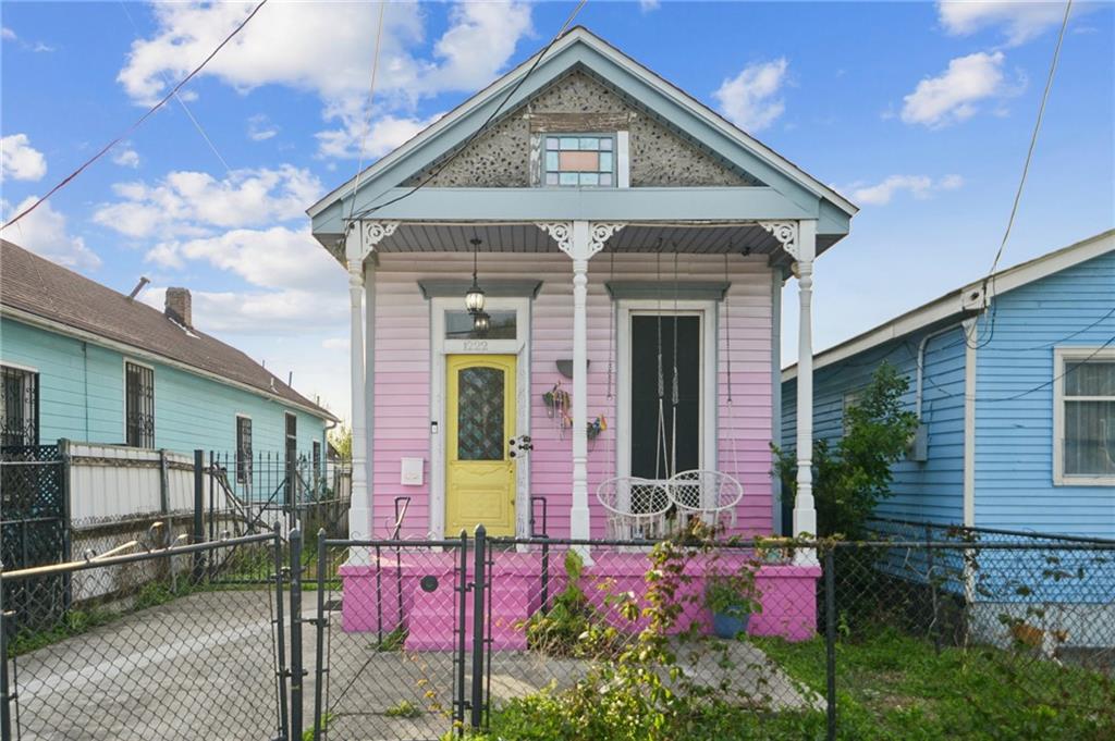 Renovated and full of charm, this spacious 2-bedroom, 2-bath home blends classic New Orleans character with thoughtful modern updates. Soaring ceilings create an open, airy feel throughout, complemented by an open floor plan designed for comfortable everyday living and easy entertaining. The kitchen features an island with seating, marble countertops, and stainless steel appliances, while the stylishly updated baths and in-unit laundry add modern convenience.Outdoor space features a side deck with a storage shed, and deep backyard—ideal for relaxing or entertaining. A gated driveway provides convenient off-street parking for multiple cars.Conveniently located near St. Claude Avenue with easy access to neighborhood cafes, bars, and local businesses. Just ten minutes to the French Quarter, French Market, and the riverfront, placing some of New Orleans’ most iconic destinations close at hand.