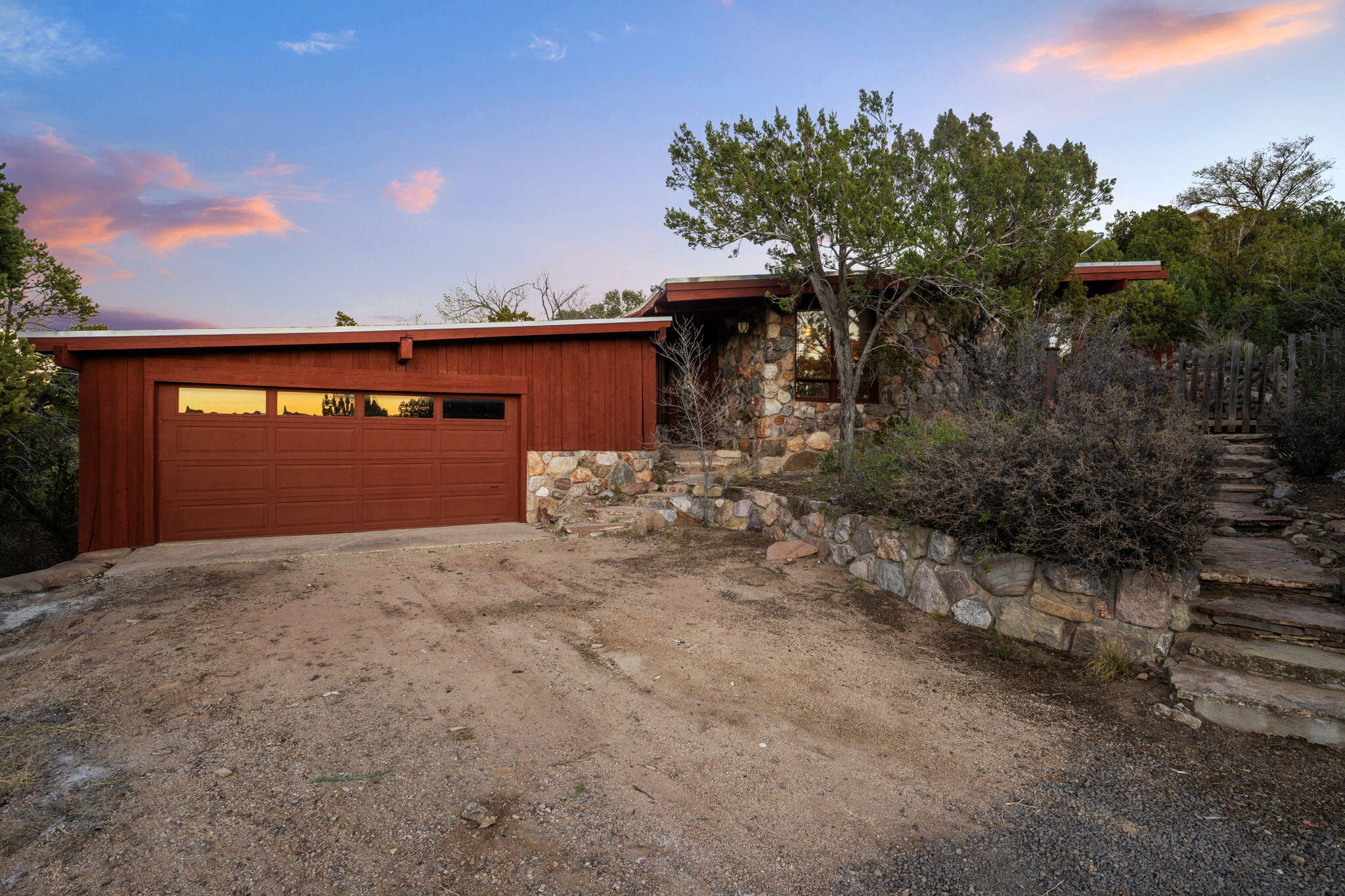Escape to your private mountain retreat in Tijeras, where beautiful scenery and sweeping views surround you on a .96-acre lot. This single-story home offers 1,877square feet with 3 bedrooms and 2 full baths.The great room features wood beams, warm paneling and a wood-burning fireplace with stone surround. The kitchen is equipped with a built-in oven, cooktop, refrigerator, and dishwasher, plus a convenient pass-through to the family dining area. Recent updates include new carpet, refinished hardwood floors, and a freshly painted exterior.Additional features include hot water baseboard heat and all-electric utilities. The property is serviced by a private well and septic system. Enjoy peaceful living just minutes from the city.