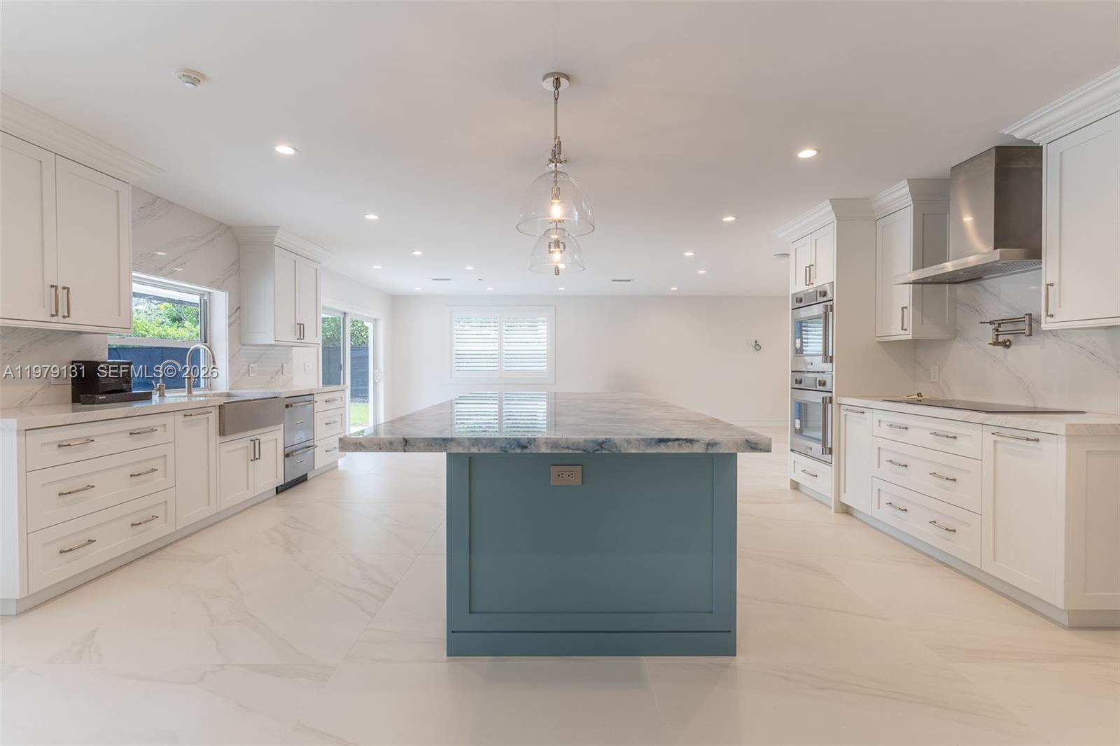 Discover an extraordinary residence—fully reimagined, meticulously renovated, and never occupied since completion. Crafted with uncompromising quality and state-of-the-art features!Step into an expansive, open floor plan highlighted by 48x48 porcelain tile, all-new ductwork, PVC piping, impact windows and doors, LED lighting, and a premium Araknis wireless network with CAT-6 hardwiring  for seamless connectivity.The chef’s kitchen is a true showpiece, boasting a grand center island, marble countertops, and a full suite of Thermador stainless steel appliances—double ovens, side-by-side refrigerator, warming drawer, water dispenser, and double-drawer dishwasher—paired with custom cabinetry designed for both elegance and function. Spa-inspired bathrooms  including a primary suite with an air-jet soaking tub and designer shower wall. All bedrooms feature California Closets, and the home includes a spacious utility room with sink !Outdoors, enjoy a generous bricked patio and sparkling pool overlooking a tranquil waterway &, fully fenced garden—your private retreat. Additional upgrades include over  $50K in energy-saving solar panels, new Ring spotlight cameras, and a full alarm system. Renovations were completed with ADA-conscious design in mind, and architectural plans for a new covered front entrance are included.Perfectly located within walking distance of top-rated schools and parks, this rare offering is truly move-in ready.—your dream home awaits.