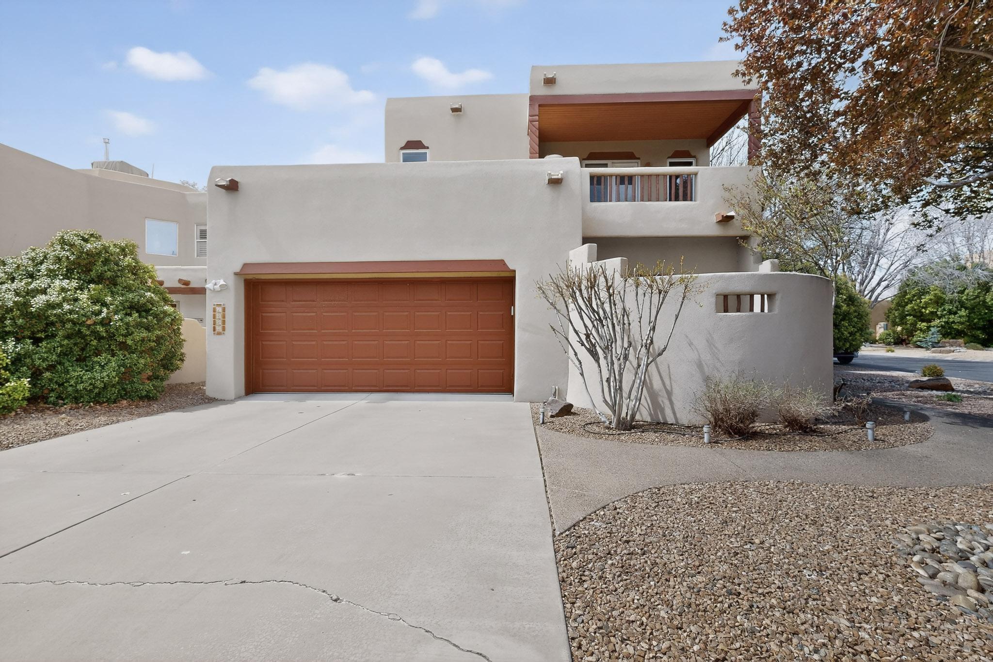 Step into this breathtaking Southwest-style two-story home, brimming with authentic charm and character. The soaring Viga ceilings, an adobe stairway, and a cozy kiva fireplace create a warm and inviting atmosphere in the living area. Bathed in natural light, the open-concept layout effortlessly transitions into a spacious kitchen and dining area, featuring a generous island, gas cooktop, and plenty of countertop space--perfect for both everyday living and entertaining guests. The primary suite on the main level serves as a private retreat, complete with its own patio, a jetted tub, and ample room to unwind at the end of the day. Upstairs, the second bedroom offers a delightful private balcony, ideal for sipping morning coffee or enjoying sunset views. Additional amenities include ceiling