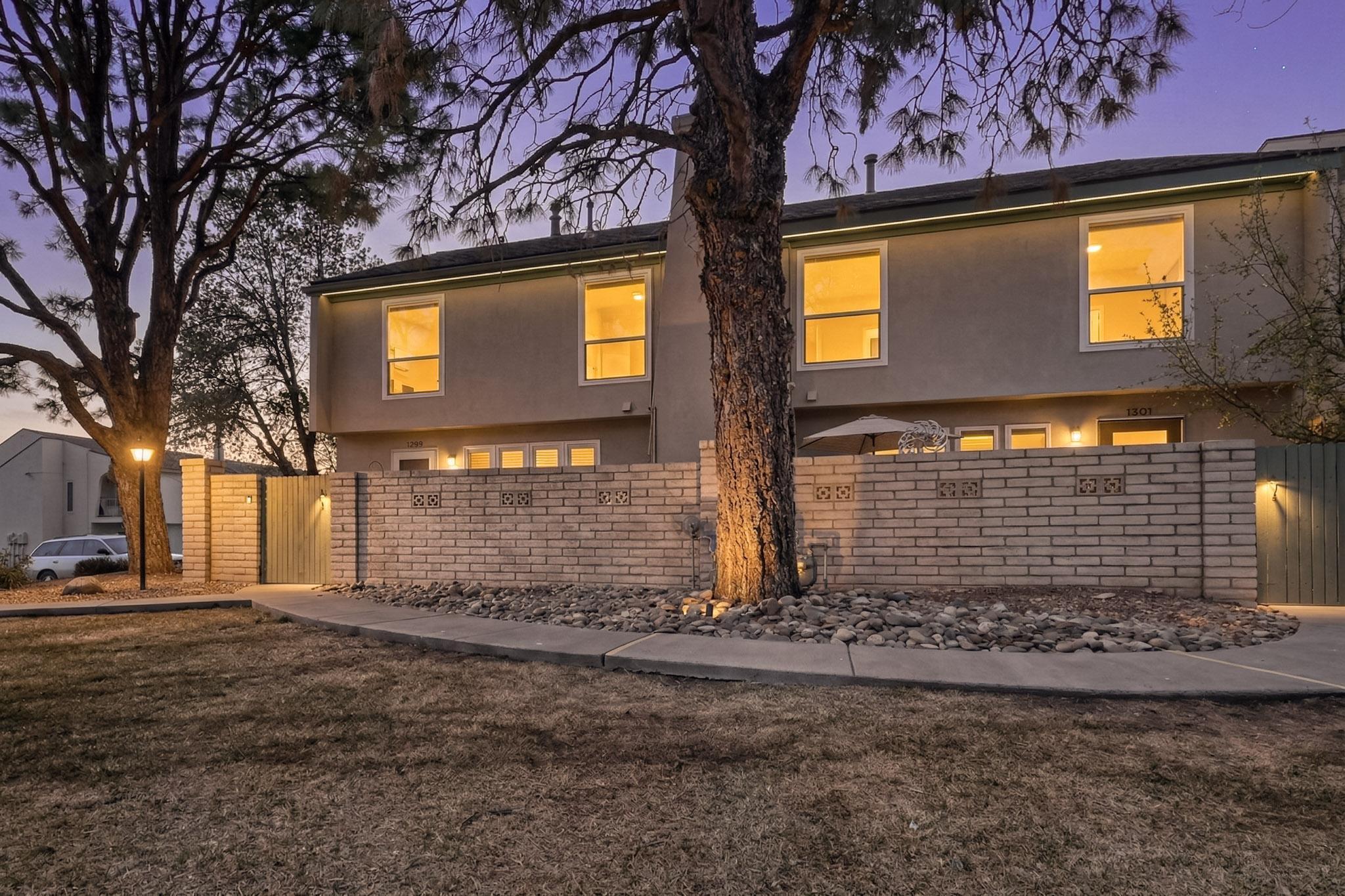 Charming two-story townhome in a prime central Albuquerque location! Affordable 3-bedroom home offers a warm and inviting layout, complete with a cozy fireplace and a private courtyard--perfect for relaxing or entertaining. Enjoy the convenience of a one-car garage and access to a community pool for those sunny New Mexico days. With its ideal location close to shopping, dining, and everyday amenities, this home combines comfort, convenience, and low-maintenance living.  Sold ''As Is'' and priced accordingly.  Come see today