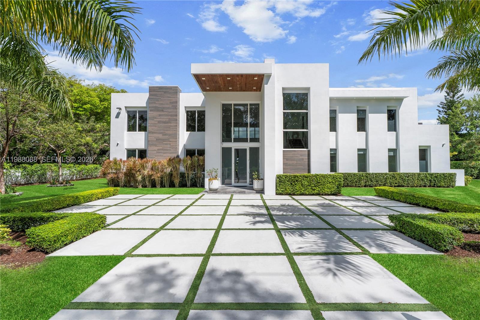 An exceptional gated Pinecrest estate on a corner lot spanning over 37,000 sqft. Architecturally designed to perfection w an open floor plan that flows beautifully. Glass sliding doors, volume ceilings, & abundance of natural light seamlessly blend indoor/outdoor living. Chef's kitchen with Wolf/SubZero appl, custom cabinetry, quartz counters, wine cellar & walk-in pantry. The primary suite is a true retreat with a spa bath, dream closets & a modern fireplace. Italian built-in closets w interior lighting in all bedrooms. Smart home technology, electric blinds, & generator. Air-conditioned 3 car garage with epoxy floors & custom built-ins. A spectacular backyard with a resort-like pool, summer kitchen & soccer field. Located near top-rated private schools, golf course & exclusive yacht club