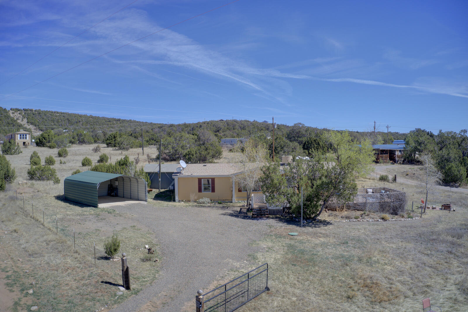Get away from the city into the hills & valleys of Edgewood. This lovely home offers 3 bedrooms, 2 full bathrooms, a newer water heater, newer bathroom faucets, & tastefully painted, and an awesome front deck overlooking the acre it sits on. There are 2 lots 1/2 an acre each with 2 codes. Country living with easy access to town. The house is nicely situated on the back of the lot away from the road. The yard is fully fenced with a large deck to enjoy outdoor living, with some mature xeriscaping and fruit trees!