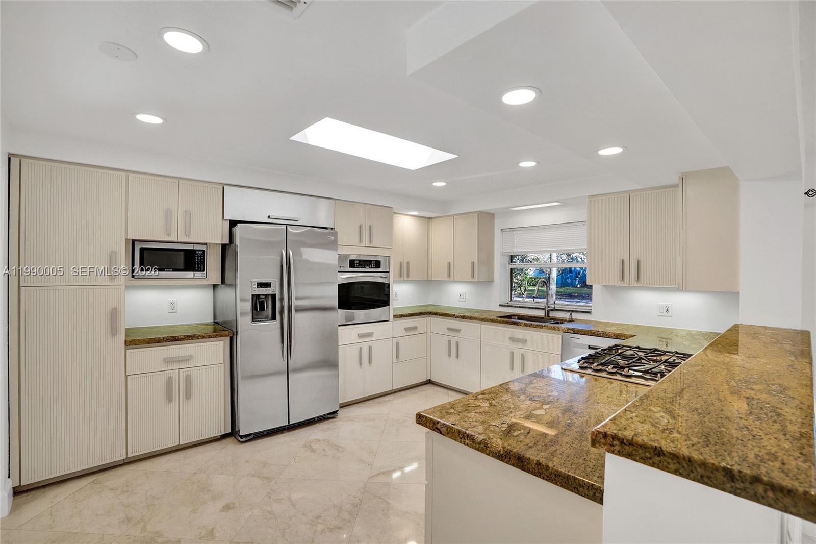 Modern kitchen with designer features at 20 101st St - Home in Miami Shores