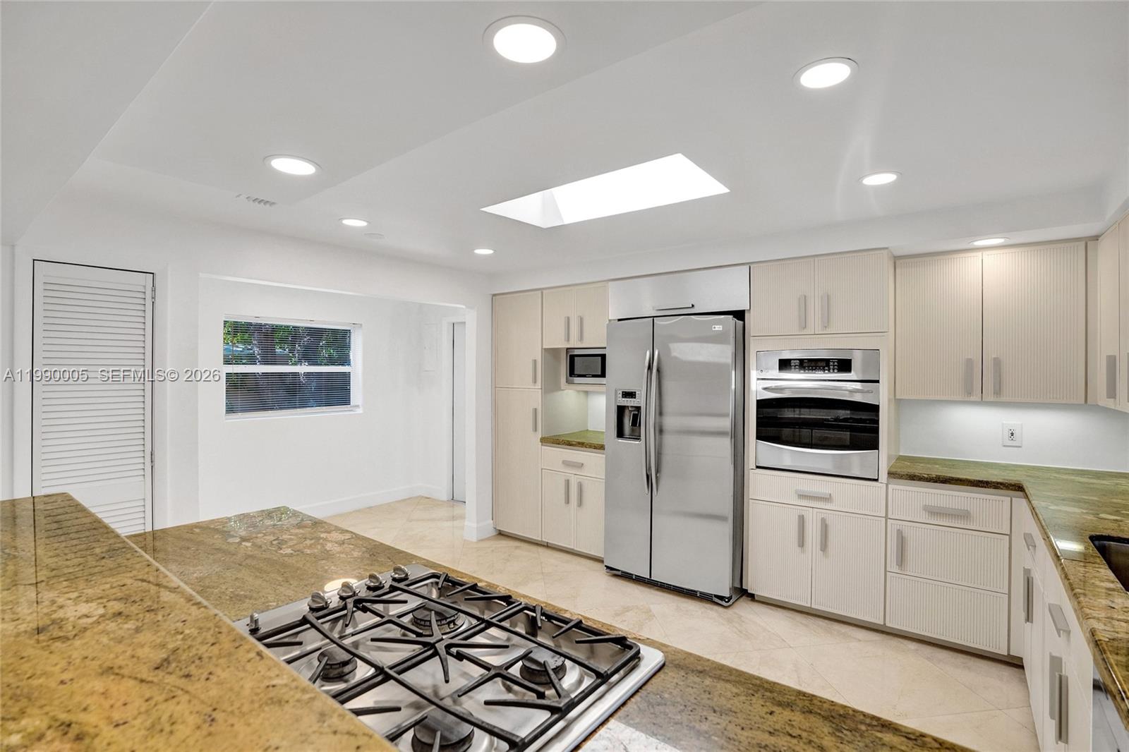 Modern kitchen with designer features at 20 101st St - Home in Miami Shores