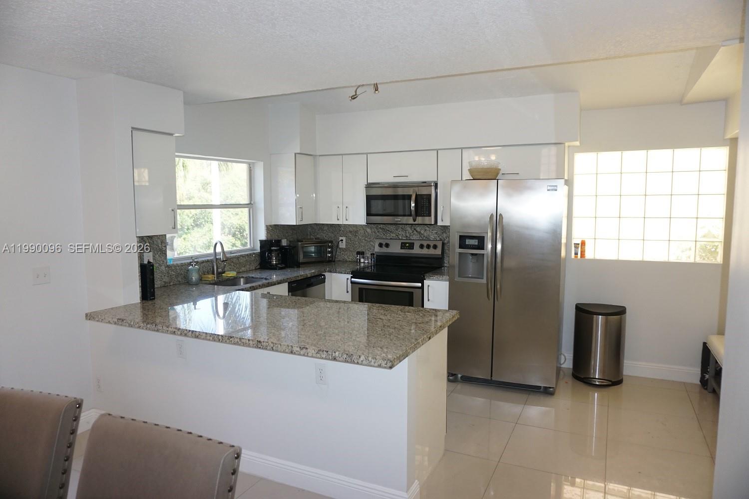 Modern kitchen with designer features at 1057 6th Ave - Home in Dania Beach