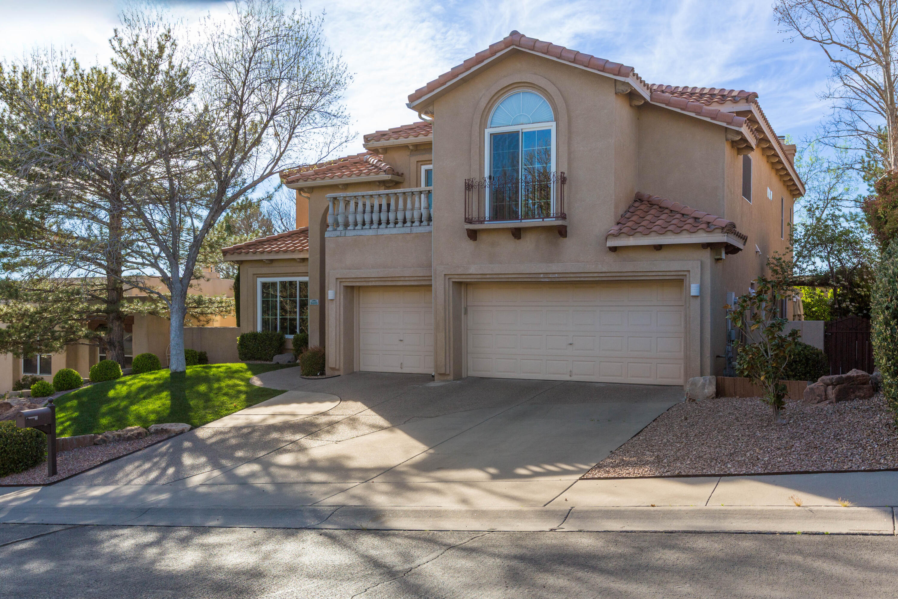 Set on a quiet cul-de-sac w/in the prestigious gated community of Tanoan East, this exceptional residence is minutes from the clubhouse.  Main living spaces are light filled, featuring a sophisticated living room w/a gas fireplace, a formal dining room & a warm, inviting family room w/its own fireplace. Beautifully updated kitchen w/granite counters, stainless appliance & a dining area.  Main-level suite-ideal as a guest retreat or home office, features its own ensuite bath. Upstairs, primary suite w/a private balcony & a double-sided fireplace that creates a serene ambiance from bedroom to bath. The spa-inspired ensuite offers a Jacuzzi  tub, a separate walk-in shower, &spacious walk-in closet. Three additional well-appointed bdrms & a full bath complete the upper level.