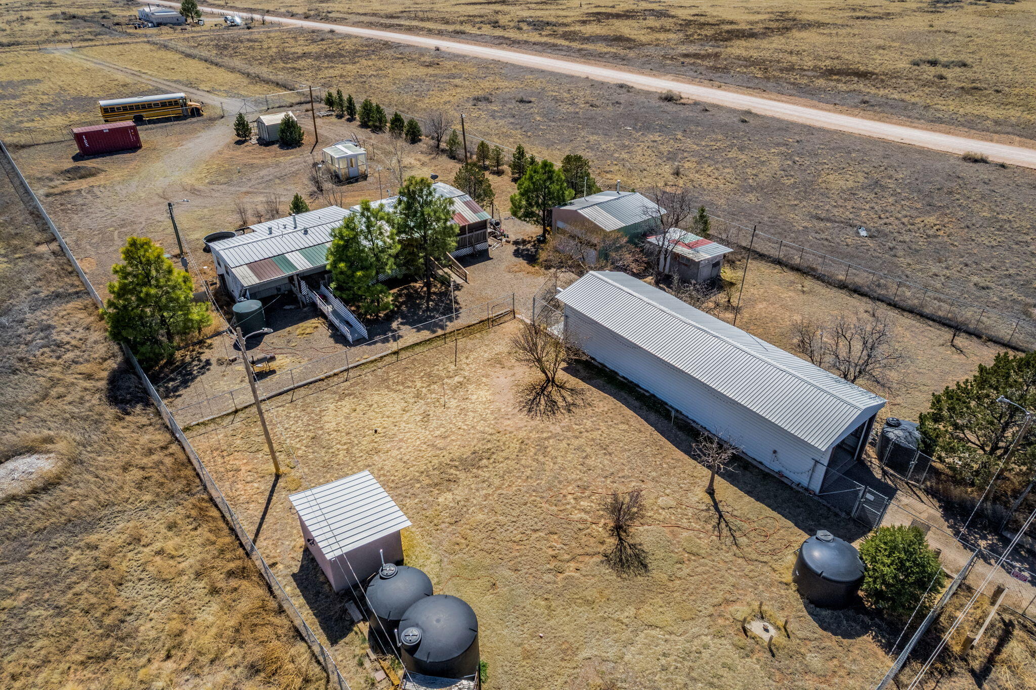 Great opportunity to own THREE lots in McIntosh, offering space, flexibility, and endless potential. Two of the lots are fully fenced, providing added functionality and privacy.The main parcel features multiple outbuildings including two garages, a storage container, greenhouse, and storage shed--ideal for projects, storage, or hobby use. Property is equipped with a full water haul system with a new pump, irrigation setup, and a newer septic system already in place.A manufactured home is present on the property and will convey in its current condition. This property is perfect for someone seeking wide open spaces, fresh air, and the chance to create their own vision from the ground up.Property is being sold as-is. Cash sale only.