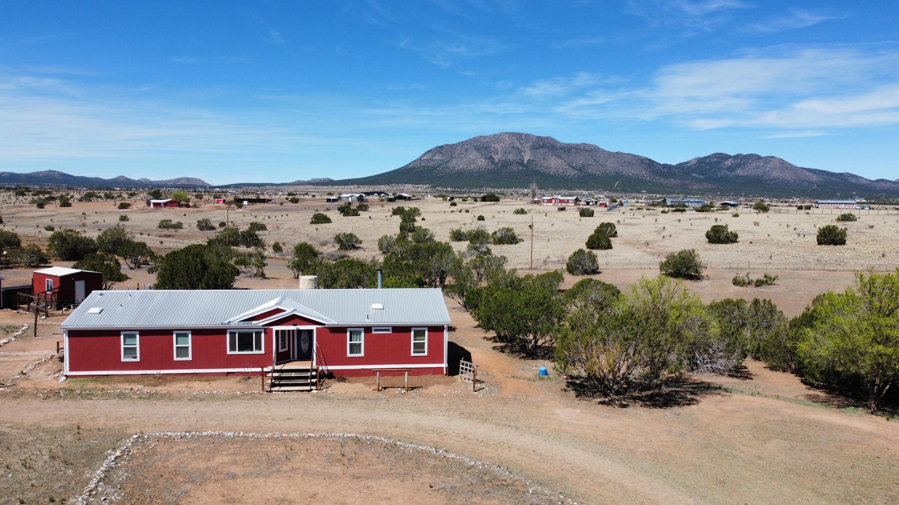 BRING YOUR HORSES and any other livestock you have to this amazing 10 acre property!  Boasting a 40' by 60' barn with chicken coop, hay storage and tack room with enough room for 5-6 stalls.  Also is a separate 4 stall barn, 2 round pens and a 12'X16' (est) workshop with electricity.  Not to mention the large home with 4 bedrooms, 2 bathrooms and beautiful views of South Mountain!  This property also has natural gas (no propane costs) and community water (no well to deal with)  Please see attached list of all the improvements and upgrades to this property.  Note: Mini donkeys being fostered from Long Ears Safe House and the other livestock on the property do not convey.  Make an appointment today to come see this spectacular property!