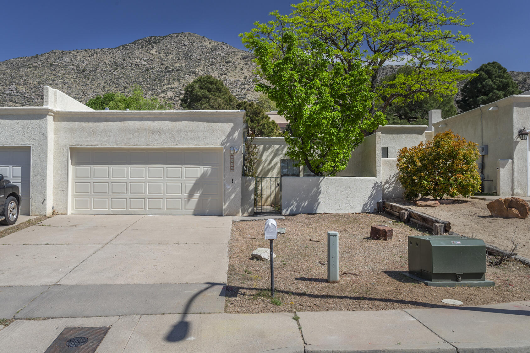 NO HOA!! Foothills living just 4 blocks from the Tramway bike trail and only 1/2 mile from the Piedra Lisa Trailhead in the National Forest! One level townhome with two bedrooms, two bathrooms, and office. Gated courtyard entry leads into generous living room with gas log fireplace, formal dining room, and kitchen with breakfast nook. Abundant natural illumination from several skylights. East-facing sun room/enclosed patio opens out to terraced backyard. Primary suite with dressing room + bath with double vanity. Oversized laundry room (extra storage!) and double garage with opener. Quiet cul-de-sac means reduced traffic; shopping and dining are easily accessible via Tramway.