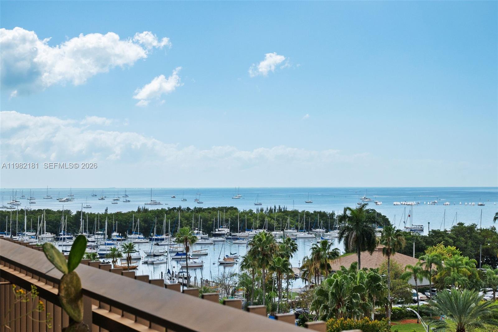 Designed by renowned architect Kenneth Treister, Yacht Harbour is an iconic building in the heart of Coconut Grove. Beautifully remodeled 2-bedroom, 2-bath residence with impact windows, beautiful wood floors throughout, and a spacious private balcony with breathtaking views of Biscayne Bay and the Coconut Grove Sailing Club. Features include in-unit washer and dryer, additional storage, one covered parking space and courtesy valet for guests. Full-service building with 24-hour lobby attendant, complimentary valet, and on-site management for effortless living.Amenities include two lighted tennis courts, heated pool, gym, sauna, outdoor BBQ, and poolside party room.Enjoy the Grove lifestyle—morning walks along the bay, sunsets from your balcony, sailing just steps away, and easy strolls to sidewalk cafés, restaurants, parks, and the neighborhood movie theater. A perfect blend of waterfront tranquility and vibrant village living in one of Miami’s most beloved neighborhoods.