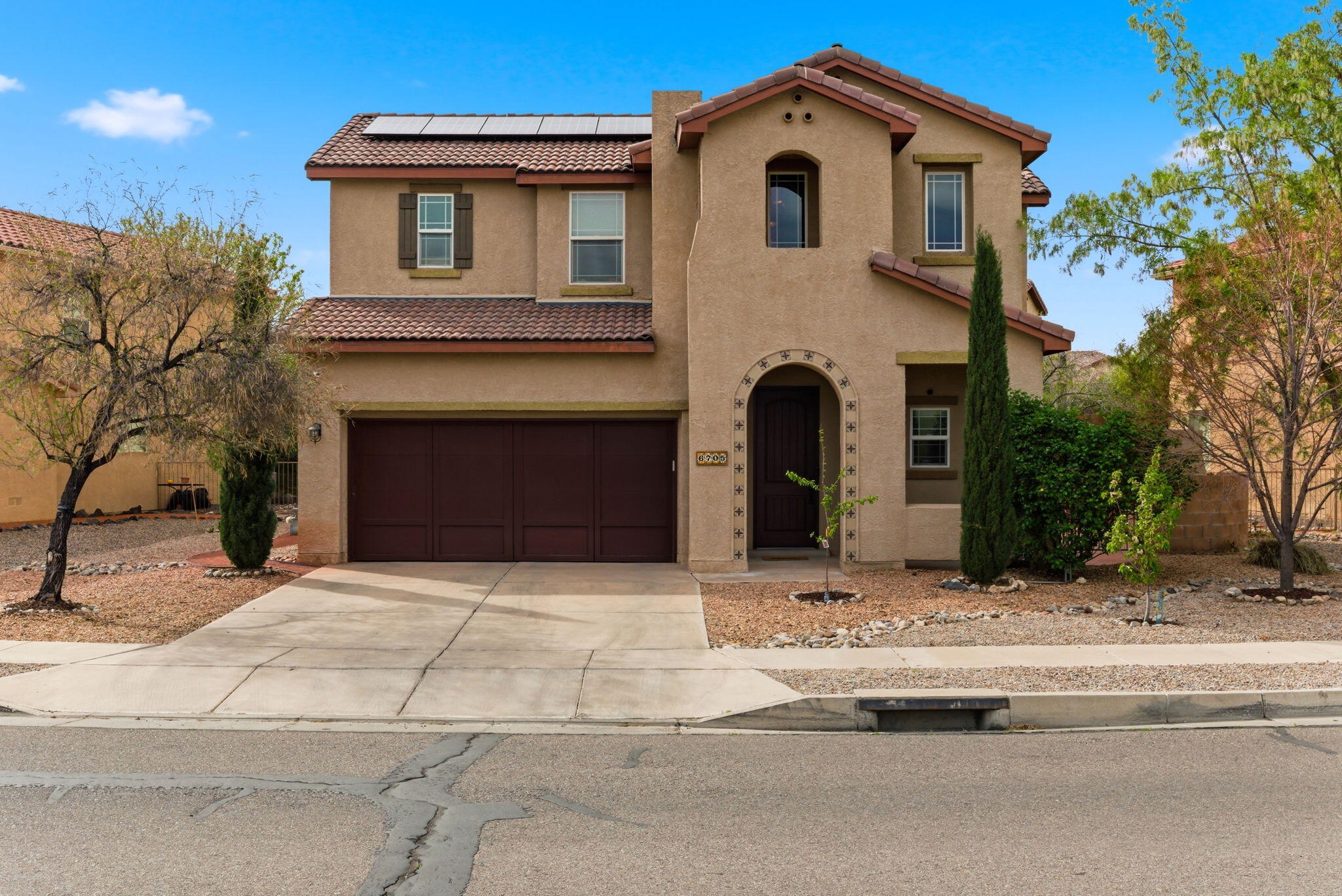 Enjoy serene views right from your front door! This beautifully designed 4-BR/4-Bath home features natural lighting, spacious rooms, storage, & custom upgrades throughout. The main level offers 2 living areas, formal dining, open kitchen with casual dining, and a private guest suite with shower. The kitchen showcases upgraded cabinetry, stainless steel appliances, quartz countertops, and tile backsplash. The upstairs features an oversized loft with built-in desk, a generous primary suite with dual vanities, soaking tub, separate shower, and walk-in closet, plus two bedrooms with a Jack-and-Jill bath. The backyard is designed for entertaining with 2 patios & kiva fireplace.  Community amenities include a clubhouse, pool, hot tub, parks, paths, all near the Petroglyphs, schools, & library.
