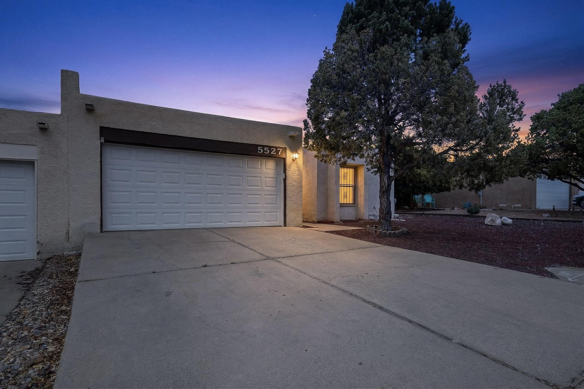 Welcome to 5527 Amistad Rd NE where Community, Convenience, and Comfort come together. This charming 3 bedroom, 2 full bathroom townhome offers 1,650 square feet of well designed living space, complete with a 2 car garage and an inviting layout. But what truly sets this home apart is the neighborhood.Located in one of Northeast Albuquerque's most desirable pockets, this property offers a rare blend of strong community feel with no HOA giving you the freedom you want without sacrificing connection or charm. It's the kind of neighborhood where neighbors know one another, creating a welcoming, established sense of community.