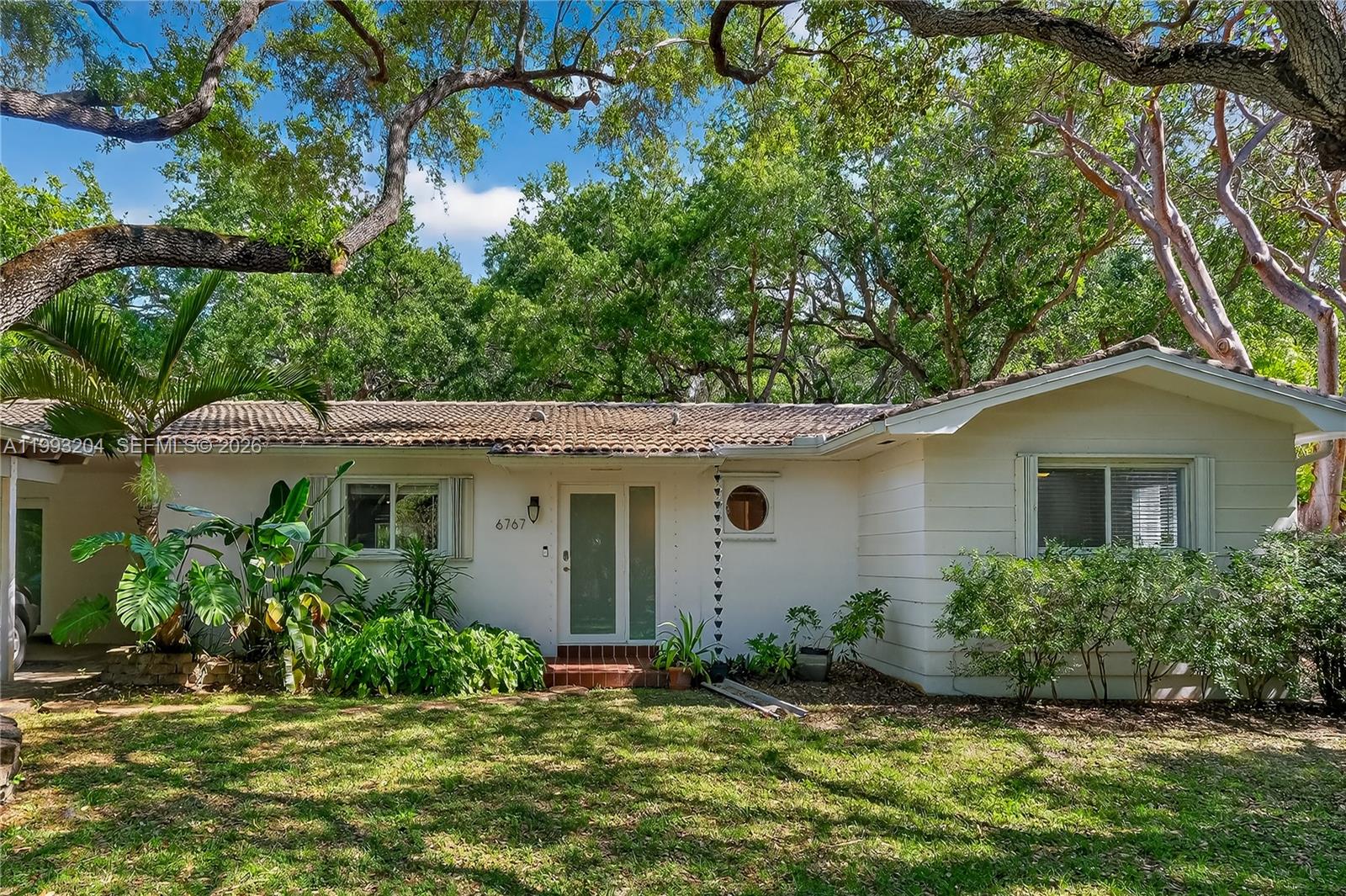 Hidden among the trees and incredible landscaping is a very warm and cozy ranch style home ready for you. Located on a dead end street gives you total privacy. The yard and area is a must see. Backs up to the Nature Preserve. Large open kitchen, living room/great room. Quartz counters, island, cabinets with multiple drawers and lots of space for a family of chefs. Separate dining area and a breakfast nook or sitting area. Tiled throughout, and wooden floors in dining area plus one bedroom, laminate in other bedrooms. Large laundry room in the big work shop/storage area with separate entrance. Easy to show, call LA for Supra info. Yard maintenance included in rent. Mango trees on the property.