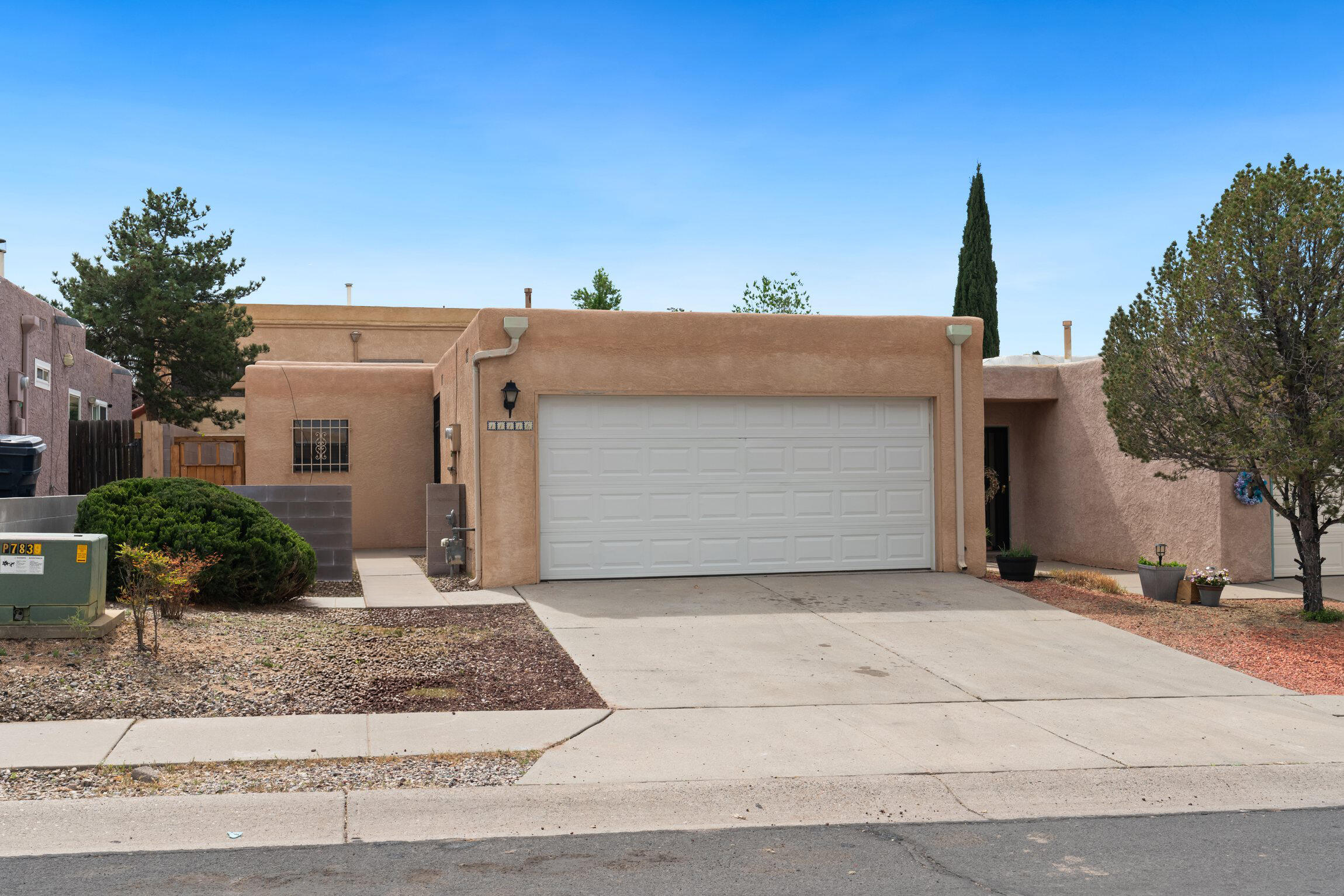 Charming 2-bedroom, 2-bath townhouse in Northeast Albuquerque! This cozy home features a secluded patio, perfect for relaxing, and flexible laundry options with hookups in both the garage and hallway. Located near the foothills, enjoy easy access to hiking trails, grocery stores, restaurants, and schools in a quiet, convenient area. Recent updates include a new dishwasher (2021), refrigerator (2022), stove (2025), evaporative cooler motor (2026), cinderblock wall (2022), garage laundry hookups (2025),  evaporative cooling pads (2026), back porch shade awning (2021), and wooden side yard gate (2023). A well-maintained home in a great location!