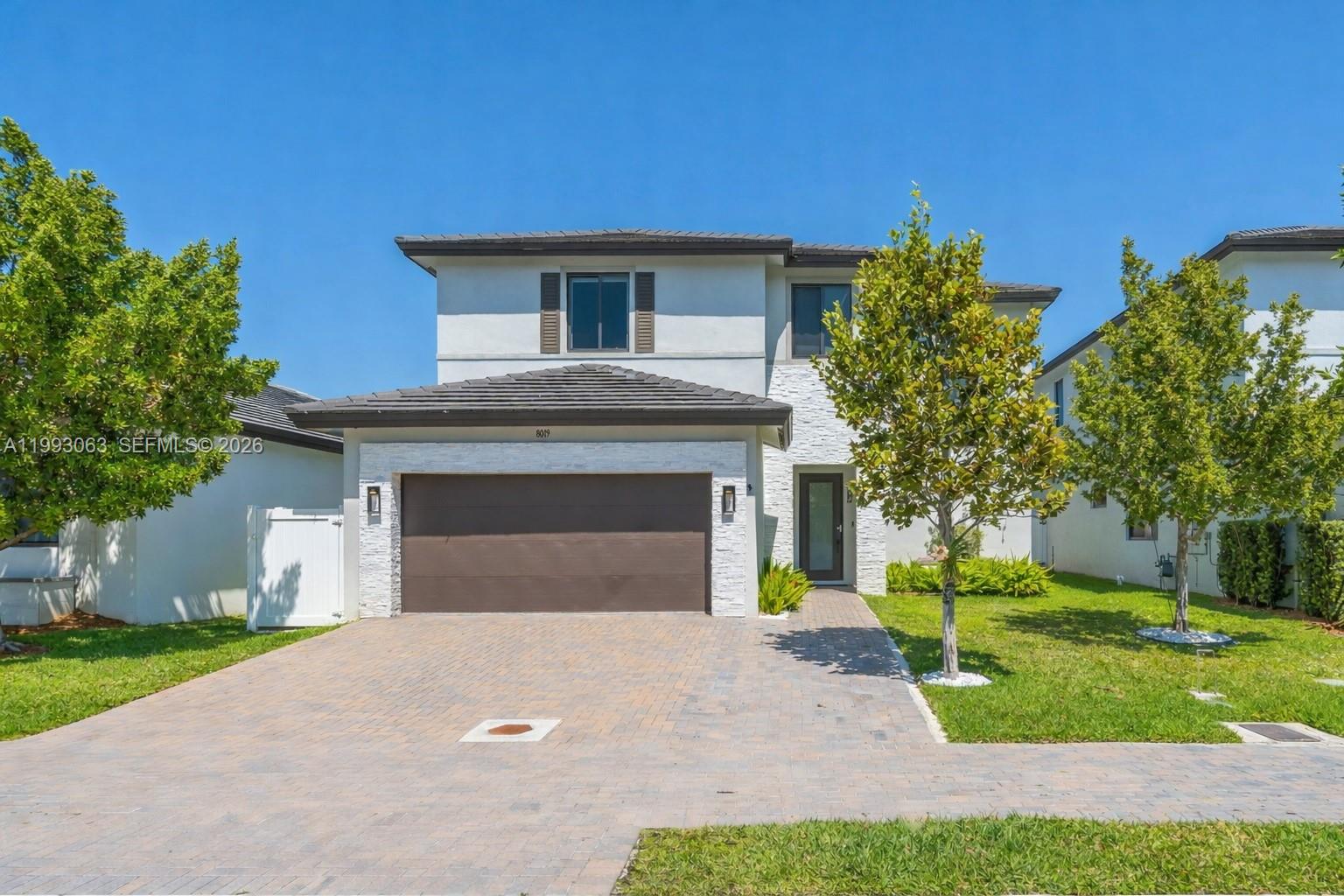 Stunning two story residence featuring 4 bedrooms plus a den, built in 2022 with over 3,400 sqft of living area, designed for sophisticated living and effortless entertaining. Located in one of Doral’s most sought after neighborhoods, this home offers the perfect balance of privacy, comfort, and modern luxury. Enjoy spacious, light filled interiors with high ceilings, seamless flow, tile floors throughout, and a beautifully designed kitchen with stainless steel appliances. A striking glass enclosed wine display serves as a refined focal point, built in surround sound system throughout for an elevated living experience. The home also offers the convenience of one bedroom and a full bathroom on the first floor. Upstairs, the primary suite features a spa like bathroom with a large walk in shower and a modern soaking tub designed for relaxation. The backyard is a private oasis with a beautiful pool, perfect for enjoying South Florida’s year round sunshine and entertaining guests. Situated in the desirable Canarias East enclave, residents enjoy a vibrant lifestyle with top tier amenities. Just minutes from Downtown Doral’s dining, shopping, and entertainment, as well as A-rated schools, parks, golf courses, and major highways for easy access to Miami International Airport, Brickell, and beyond. This is more than a home, it’s a lifestyle.