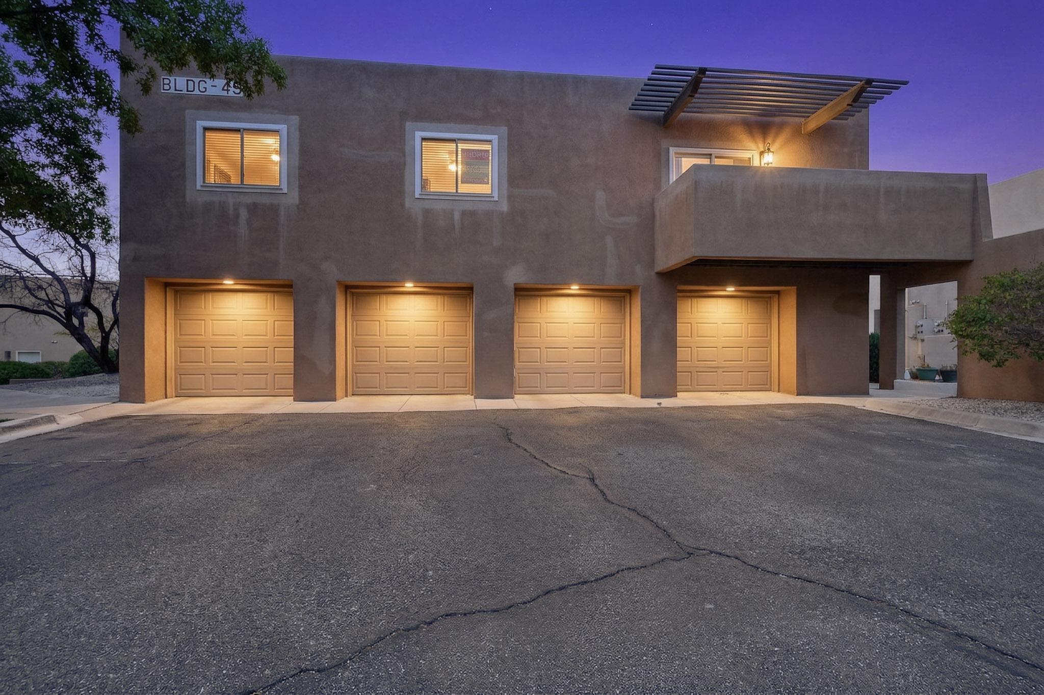 Welcome to this beautifully remodeled condo located in an award-winning complex, tucked away in a private setting in the Northwest of Albuquerque. Surrounded by mature trees and a pet-friendly environment, this home offers both comfort and convenience. Enjoy an open floor plan featuring a cozy fireplace, private balcony, and a one-car garage. Ideally located near major shopping centers, gyms, restaurants, Cottonwood Mall, Paseo del Norte, and Rio Rancho, with great walking areas nearby. The HOA covers exterior maintenance including roof, stucco, landscaping, and common areas, along with some utilities and partial insurance, and plans for a fresh stucco update.