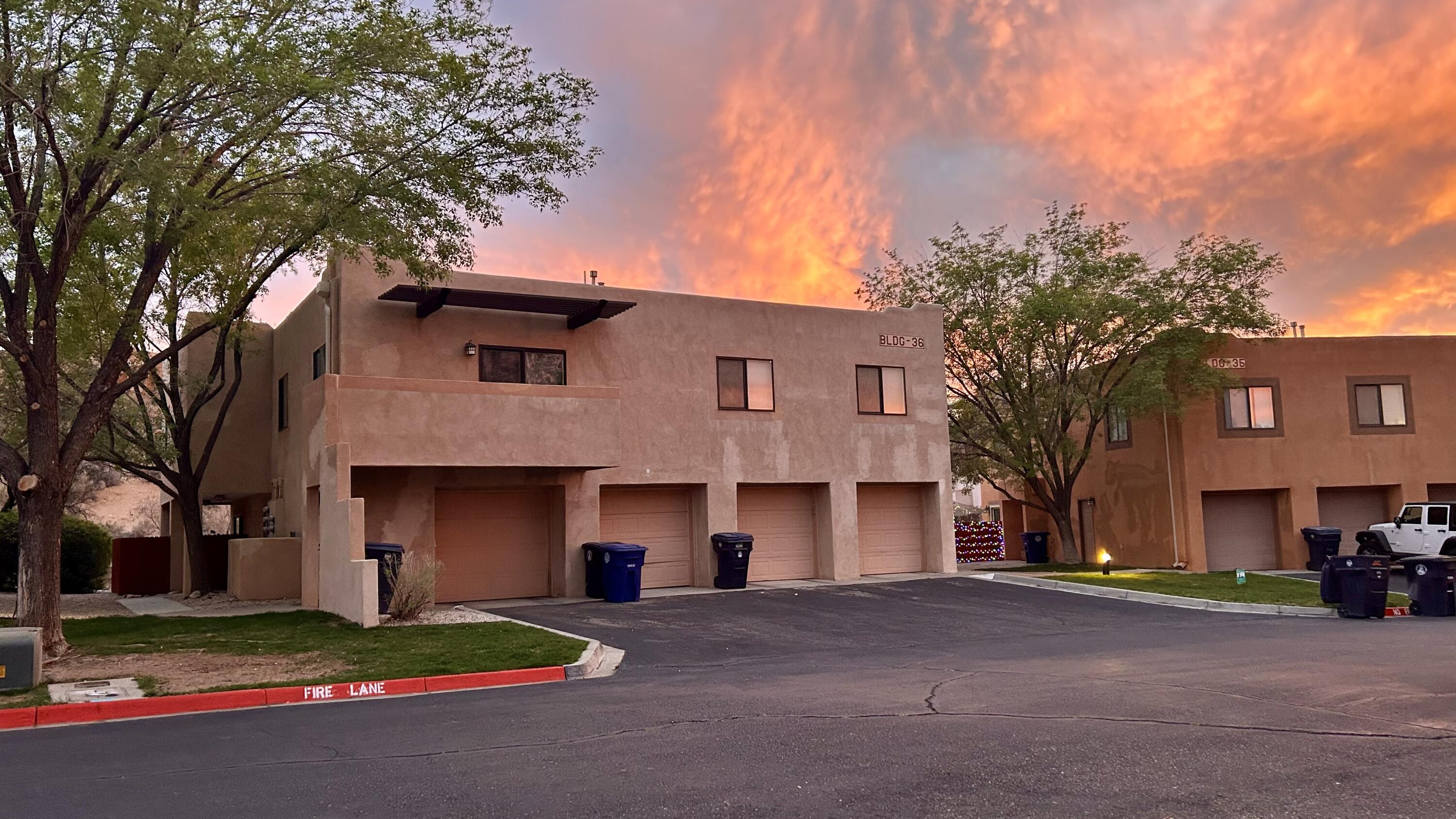 Tucked quietly within an award-winning community in the Northwest of Albuquerque, this beautifully remodeled condo feels like a hidden retreat. Framed by mature trees and set in a pet-friendly neighborhood, it offers a sense of calm while staying moments from everything--shopping, gyms, restaurants, Cottonwood Mall, Paseo del Norte, and Rio Rancho. Inside, an open floor plan flows effortlessly around a warm fireplace, creating an inviting space to unwind. Step outside to your own private patio, a perfect extension of the home. Complete with a one-car garage, this residence blends comfort and convenience. The HOA covers exterior care including roof, stucco, landscaping, and common areas, plus some utilities and partial insurance, with plans for a fresh new stucco finish.