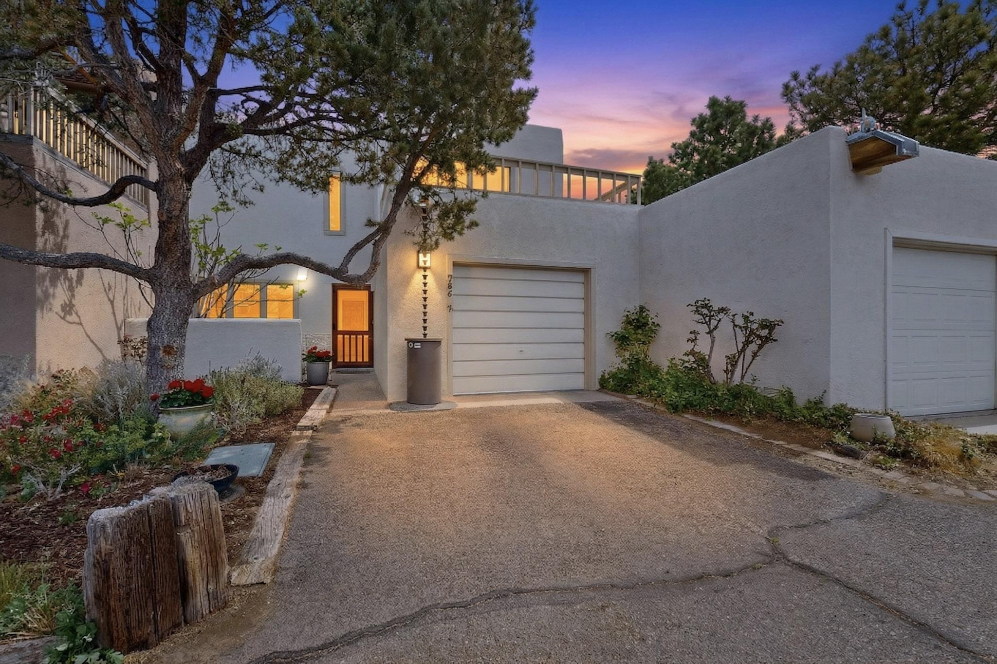 Nestled in the coveted Sandia Mountain Foothills, this enchanting townhome blends timeless Southwestern character with everyday comfort and convenience. Ideally located, this home offers easy access to scenic hiking and biking trails, along with nearby shopping, dining. From the moment you arrive, you're welcomed by rich architectural details including charming nichos & vibrant Talavera tile accents that beautifully highlight the kitchen and fireplace surround-adding warmth, color, and unmistakable New Mexico style. Step inside to discover a bright and open floor plan featuring spacious living areas filled with natural light. The living room creates a warm, inviting atmosphere, perfect for cozy evenings by the fireplace or entertaining guests while enjoying sweeping mountain & city views!