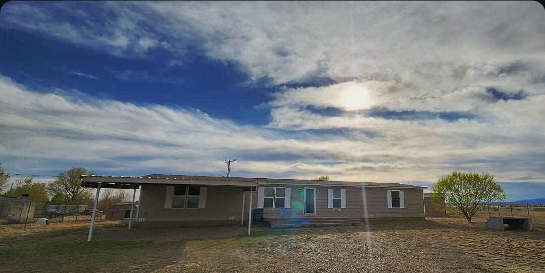 Welcome to this move-in ready 4-bedroom, 2-bath manufactured home situated on a spacious half-acre+ lot in Moriarty, NM. This property offers comfortable living with plenty of room to spread out, both inside and out. The home features a functional floor plan ideal for families or those needing extra space.Enjoy the convenience of city water and sewer, along with a fully fenced lot--perfect for pets, gardening, or outdoor entertaining. A 12'x24' shed in the backyard provides ample storage or workspace options.Don't miss this great opportunity for affordable homeownership with room to grow!