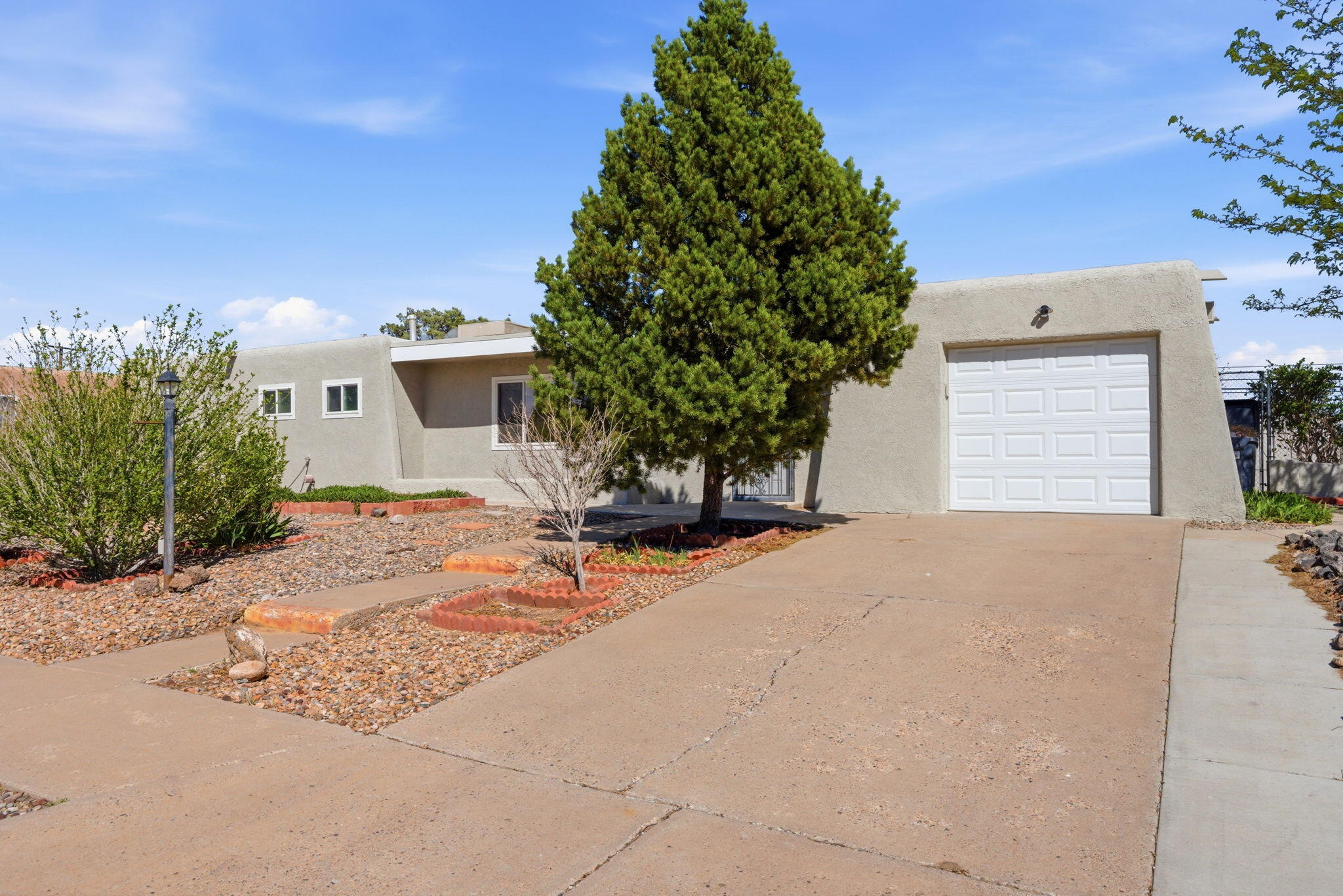 Charming single-story home on a massive corner lot in desirable Paradise Hills with backyard access and no HOA. Features a TPO roof, new exterior stucco and paint, and freshly painted interior. Functional floorplan offers two living areas plus an enclosed sunroom. Kitchen has plenty of cabinet space and a built in desk. Hall bath has been fully remodeled for wheelchair accessibility.  Newer water heater. Spacious backyard includes two storage units and a pond, offering plenty of room to enjoy, store, or create your ideal outdoor space.