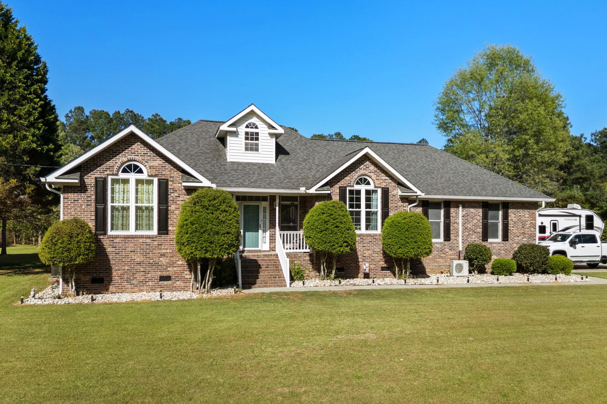 Don’t miss out on this incredible home! This beautiful all-brick 3-bedroom, 2-bath home sits on nearly 6 acres and offers a bright, spacious floor plan perfect for comfortable living. The living room features vaulted ceilings, custom built-in shelving, and a stunning fireplace. The kitchen includes white cabinetry, a new backsplash, a pantry, and a cozy breakfast nook. The primary suite offers 2 large walk-in closets and a spacious private bathroom.  The home also has a formal dining room that could easily be converted into a bonus room or additional bedroom. Step outside to enjoy the custom back porch with a relaxing patio. The backyard features a saltwater swimming pool, creating the perfect place to relax and enjoy the outdoors. There is also a huge 1,400-square-foot storage building wired for 110 and 220 with three roll-up bay doors, ideal for a workshop or extra storage. While offering privacy and space, this property is still conveniently located minutes from the beach, Historic Downtown Conway, restaurants, shopping, and more. Schedule your showing today!