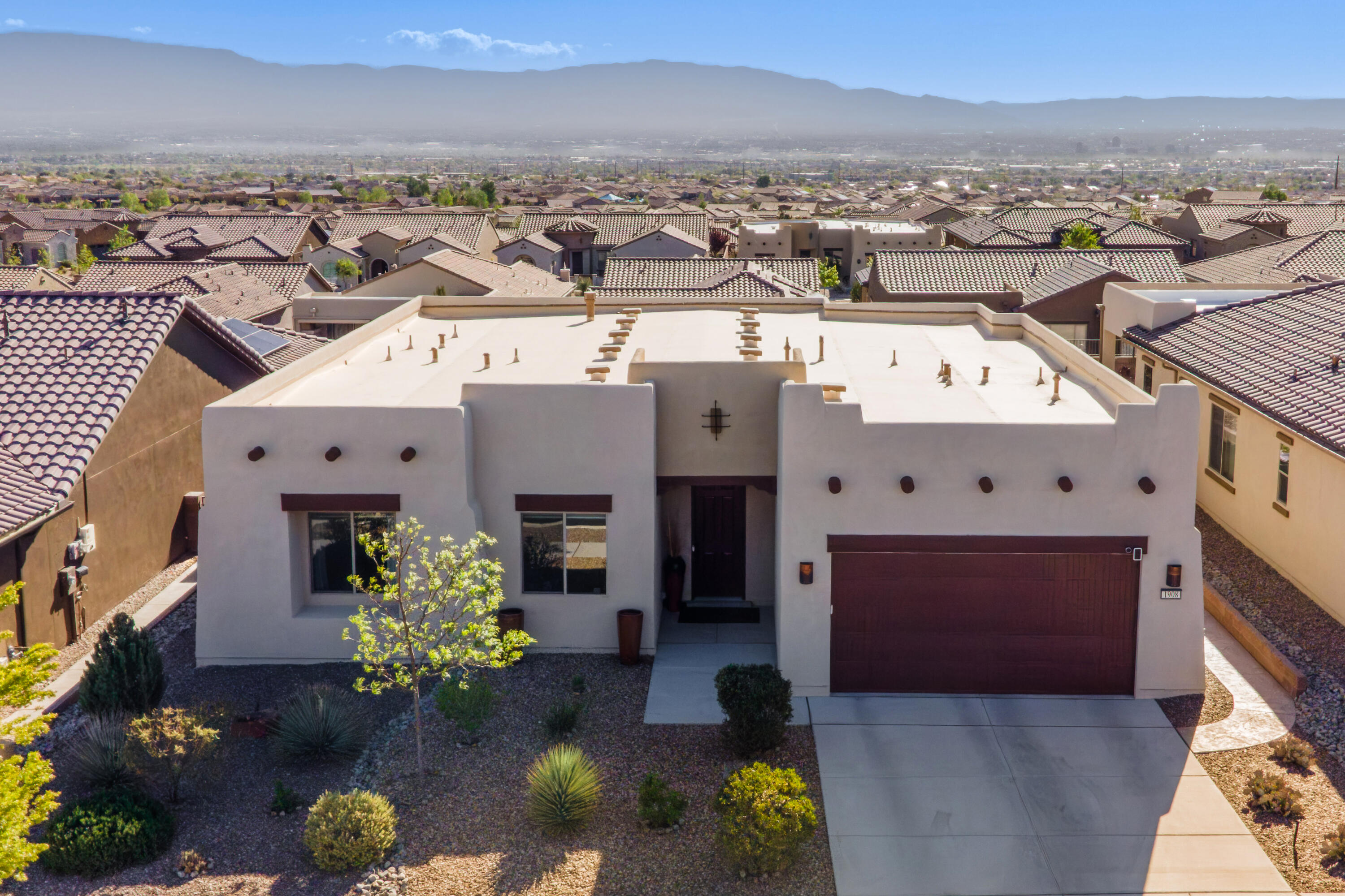 Beautiful Home with Forever Mountain and City Views in Albuquerque's Premier 55+ Active Adult Community, Del Webb Mirehaven! Built in 2020 this Pursuit Model Floorplan has 2137sf which includes a heated/cooled garage storage room, 2 BR's, 2 BA's, plus office/den or optional 3rd BR! Features include a large sliding door showcasing the views, soft arch hallways, tray ceilings, gourmet kitchen w/quartz countertops, pull-out cabinets, two ovens, wet bar w/wine fridge, reverse osmosis, nice large Island. Stylish LVP flooring, tile & upgraded carpet in bedrooms. Spacious primary suite w/ tiled walk-in shower & custom closet. Laundry w/sink, soft water system & instant hot water. Custom landscaped backyard w/stacked stone built-in BBQ, pavers, turf & plantings! Custom window shades & coverings!!