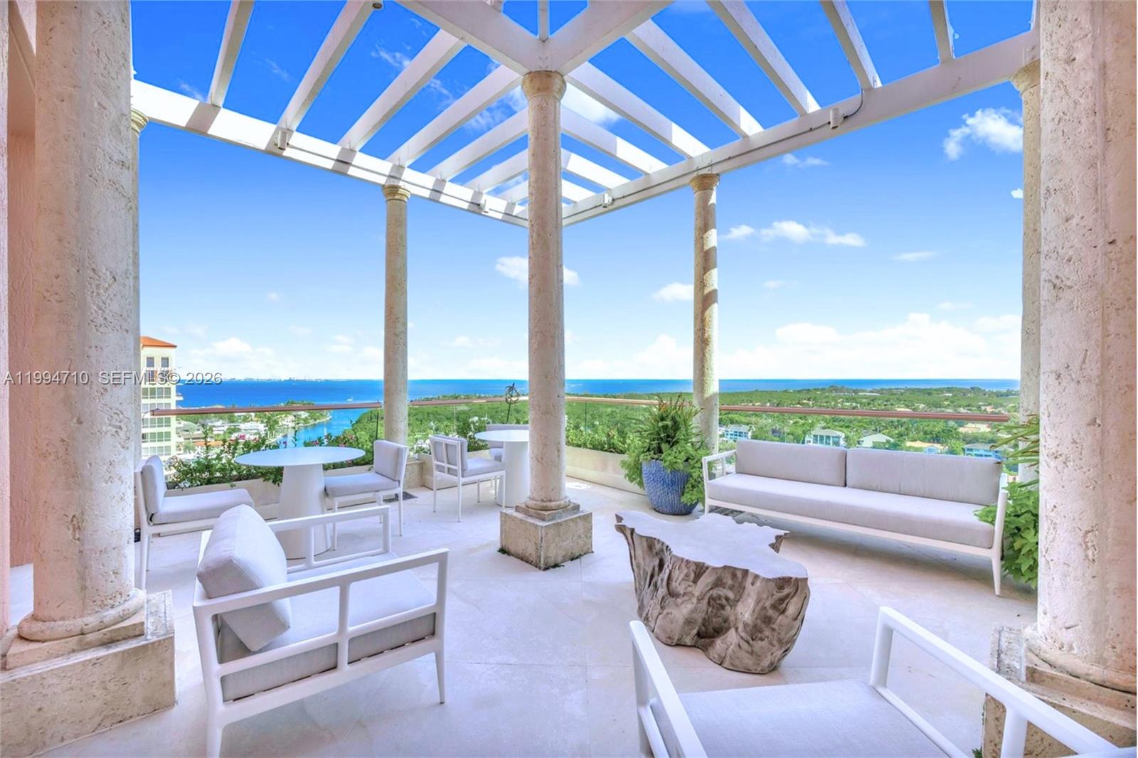 Rare two-story Tower Suite penthouse at The Gables Club offering breathtaking panoramic views of Biscayne Bay & the Miami skyline. Featuring 5 beds, 6.5 baths, & over 10,500 SF of interior space plus 2,600+ SF of expansive terraces, this exceptional residence showcases a private elevator entry, dramatic 30-foot ceilings, formal dining room, gourmet kitchen with butler’s pantry & secondary kitchen, as well as a loft-style entertainment level complete with bars, media room, and two private offices. The primary suite is a private retreat featuring dual bathrooms & oversized walk-in closets, complemented by five additional en-suite bedrooms. Finishes include limestone flooring, Venetian plaster walls, custom built-ins, and striking Chihuly-style ceiling artwork. A Crestron smart home system, surround sound, & impact windows provide modern comfort & security. Multiple terraces, including one with a built-in BBQ, offer seamless indoor-outdoor living. This offering includes three assigned parking spaces, one of which is located in a private air-conditioned garage, additional storage, & an approximately 50-foot boat slip. Residents of The Gables Club enjoy an exclusive, resort-style lifestyle with access to a private marina, multiple swimming pools and spa areas, state-of-the-art fitness centers, lighted clay tennis courts, a waterfront clubhouse with dining & social spaces, 24/7 concierge, valet, & gated security, all within one of Coral Gables’ most prestigious waterfront community.